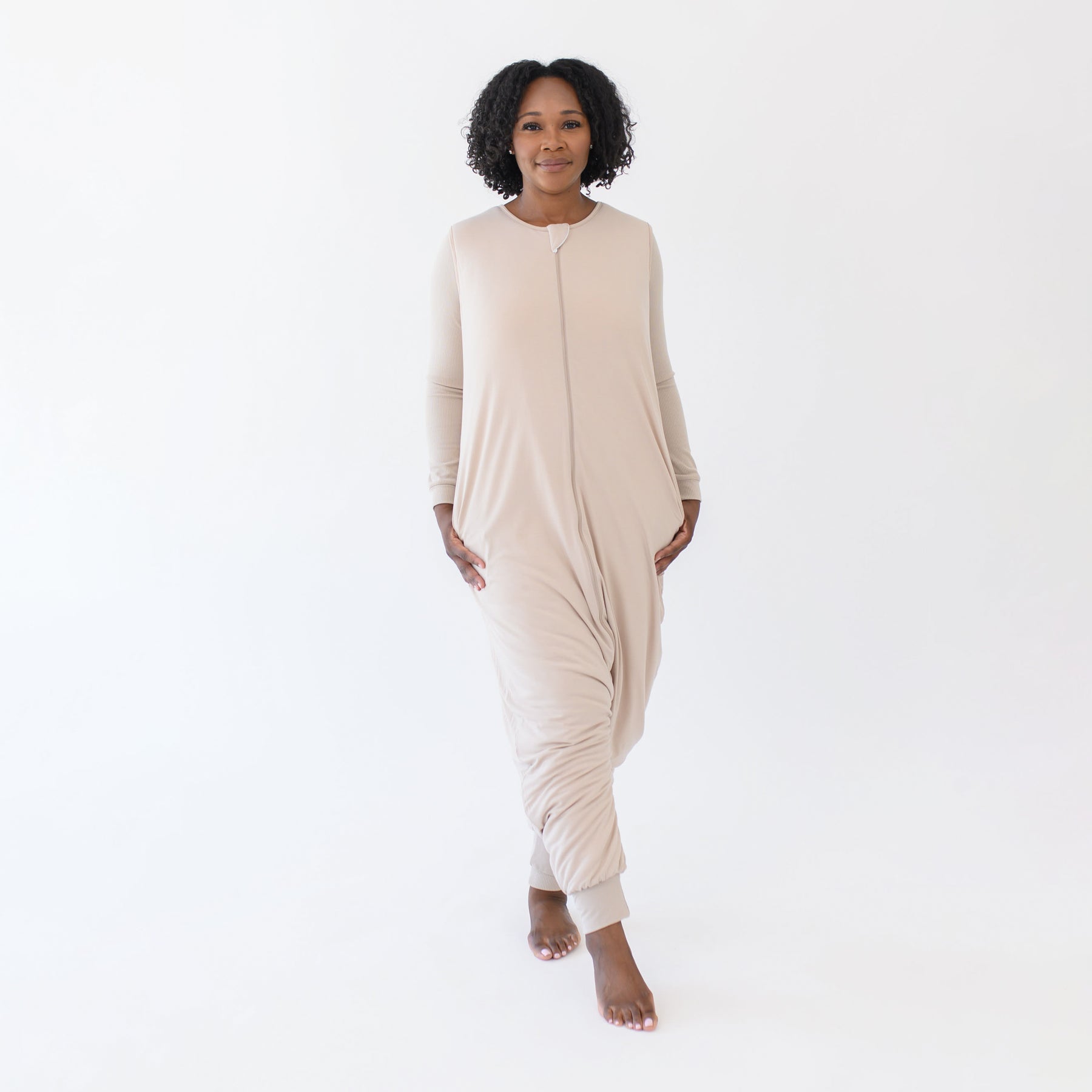 Female standing wearing the Adult Sleep Bag Walker in Bisque