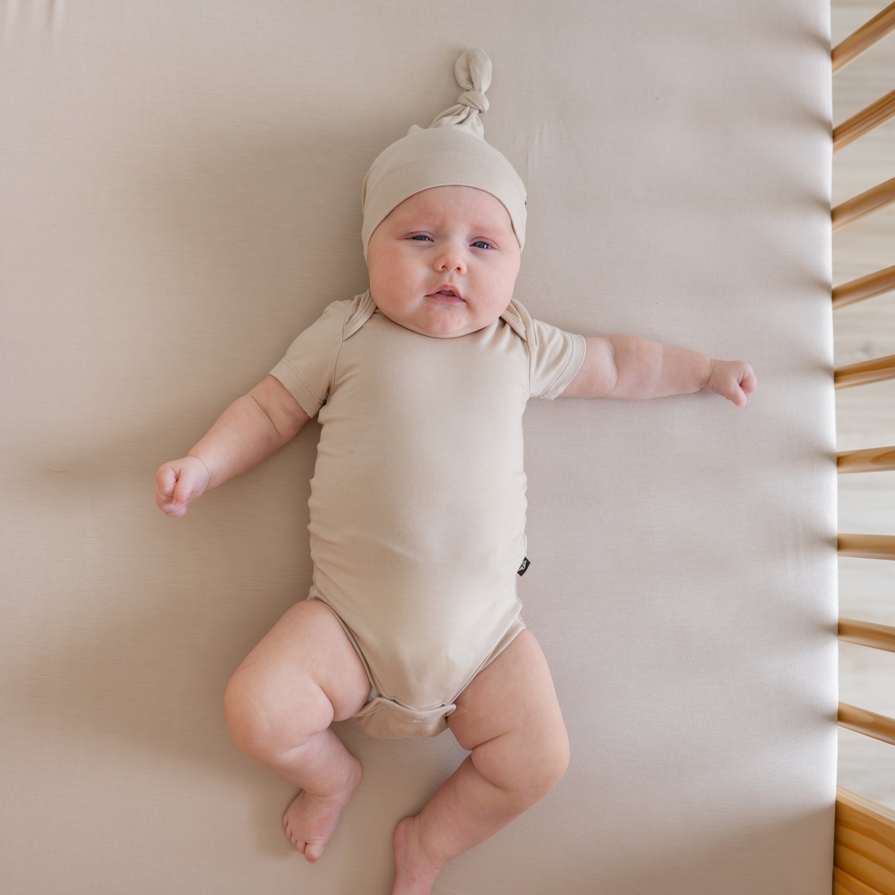 Baby wearing Knotted Cap and Short Sleeve Bodysuit in Bisque