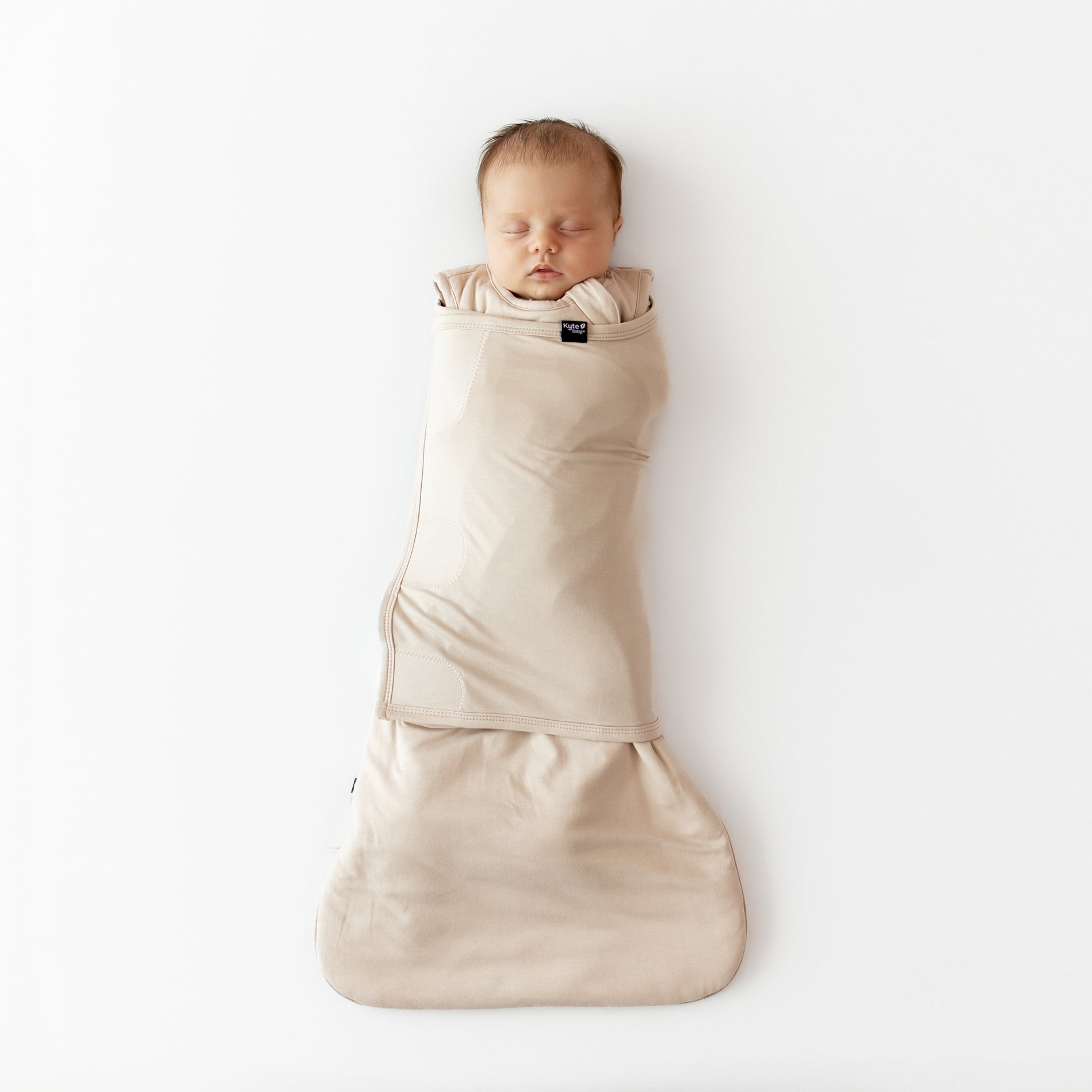 Sleeping newborn swaddled in the Sleep Bag Swaddler in Bisque 1.0