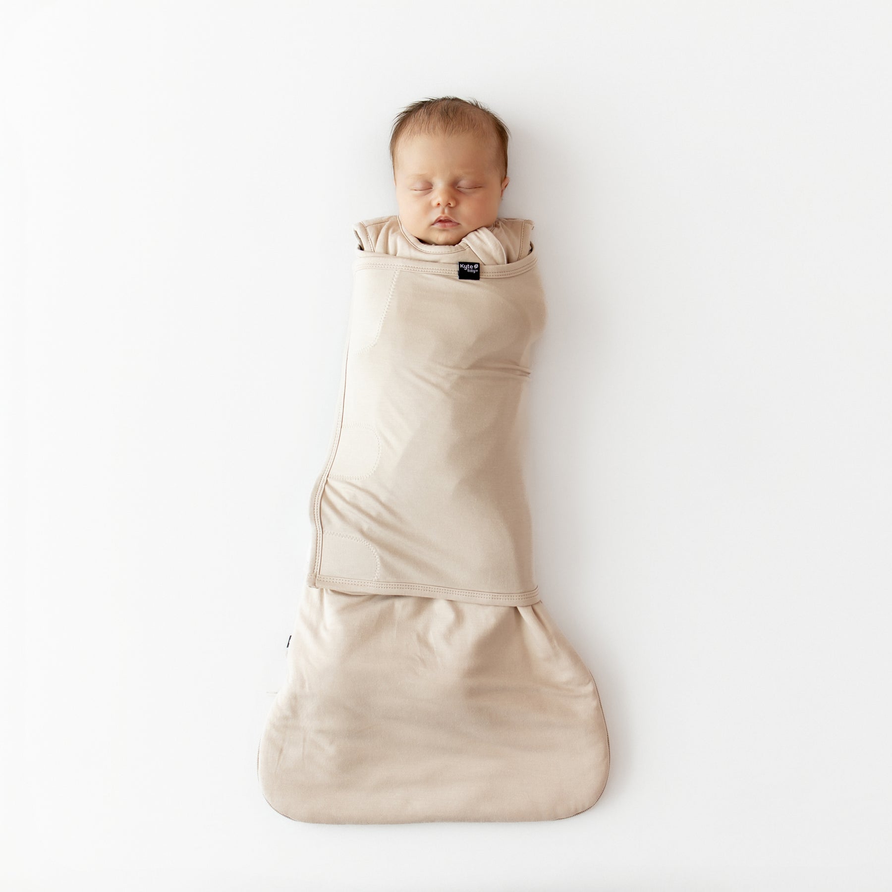 Sleeping newborn swaddled in the Sleep Bag Swaddler in Bisque 1.0