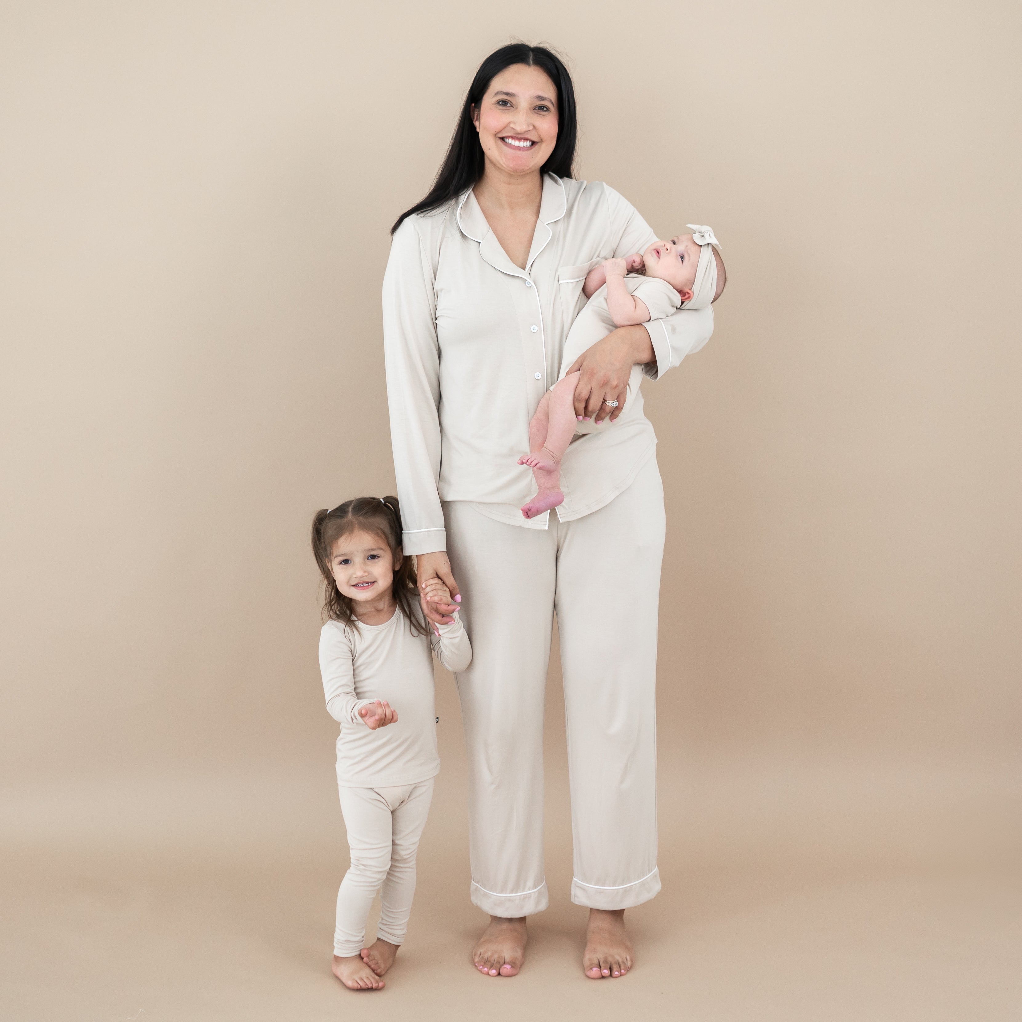 Family matching in Bisque. Pictured are the Long Sleeve Pajamas in Bisque, women's long sleeve pajama set and short sleeve bodysuit with matching knotted bow headband