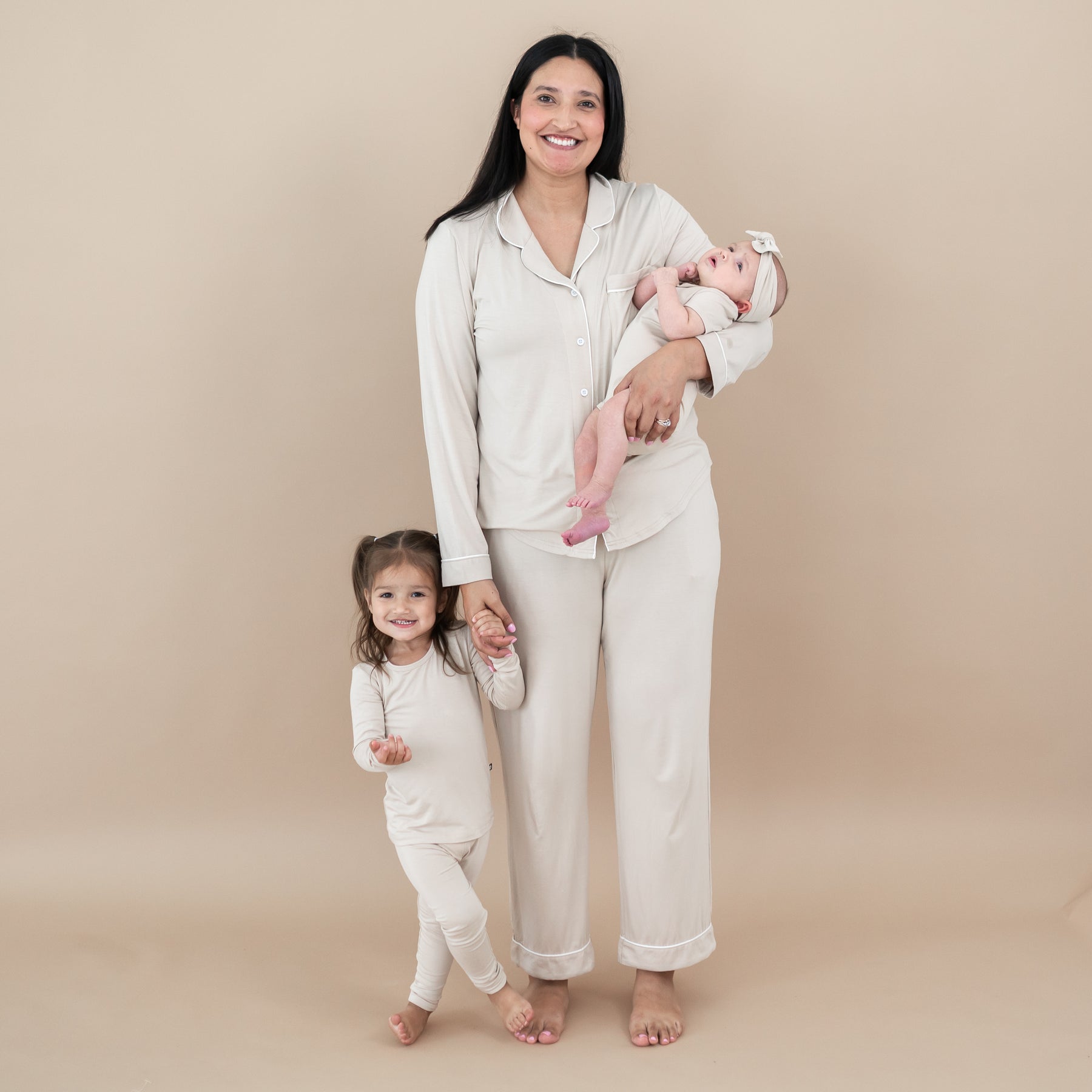 Mom and daughters wearing matching mommy and me pajamas in Bisque