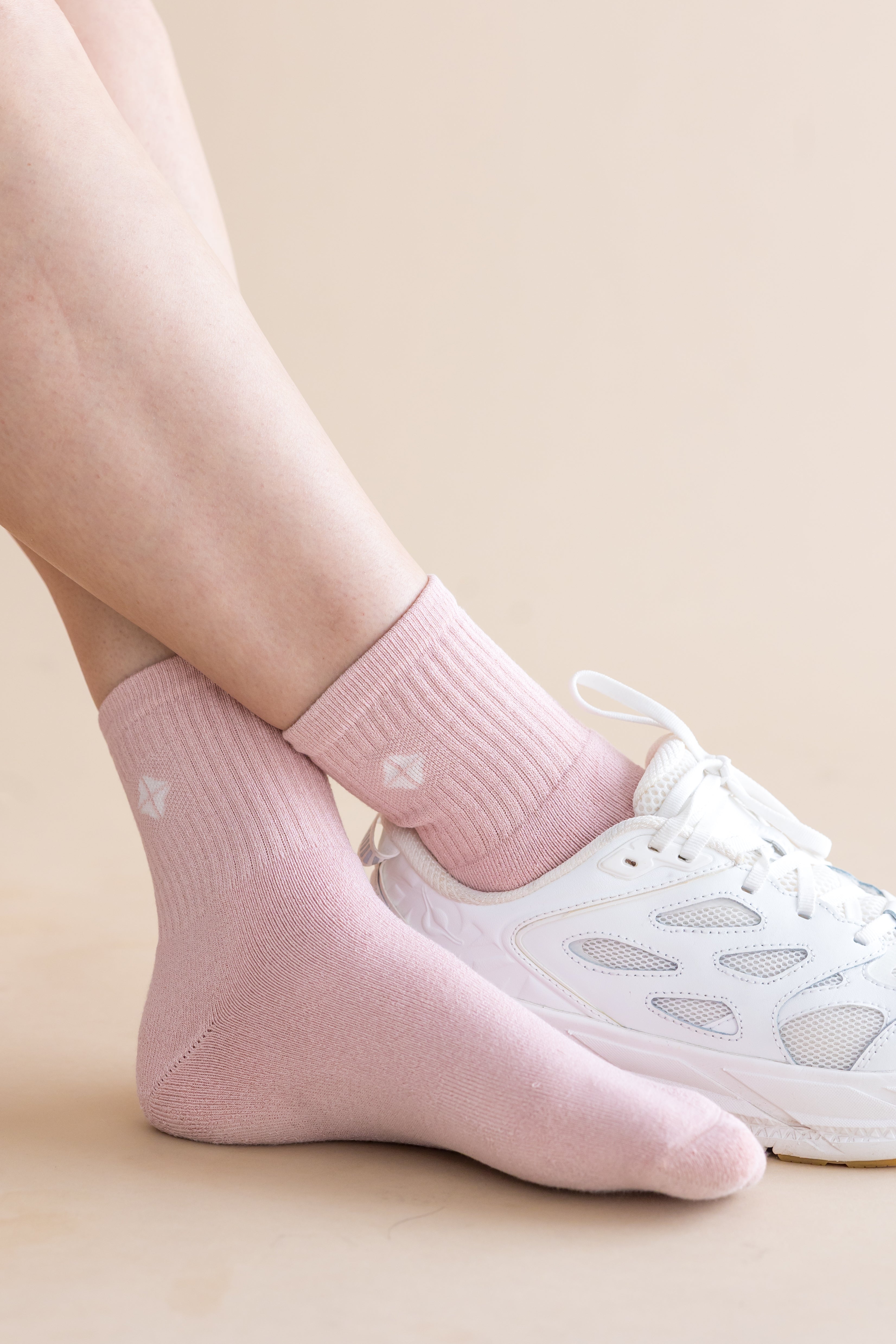 Adult Crew Socks in Blush shown on a model with one white sneaker on