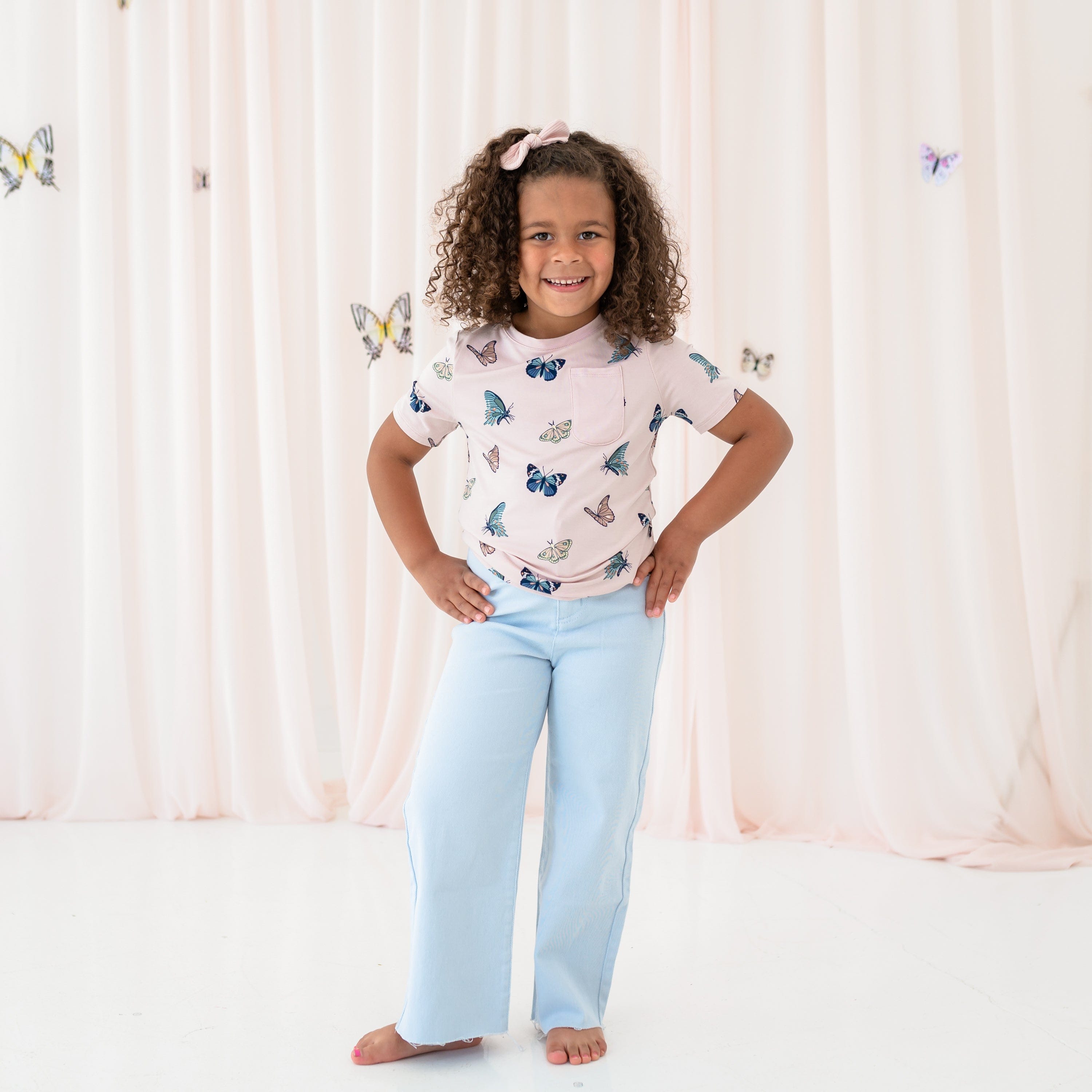 toddler wearing Toddler crew neck tee in blush butterfly and jeans