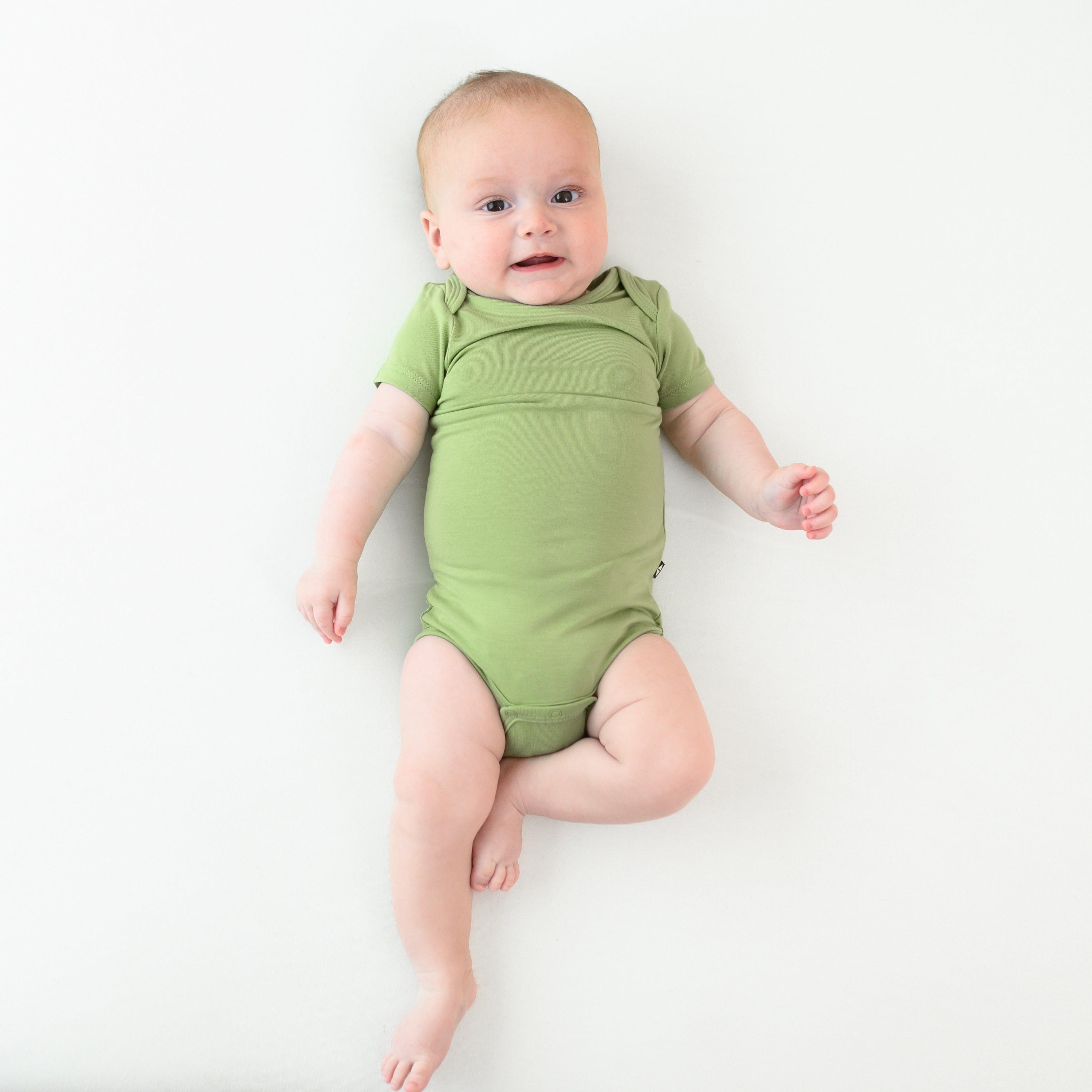 baby wearing kyte baby bodysuit in honu