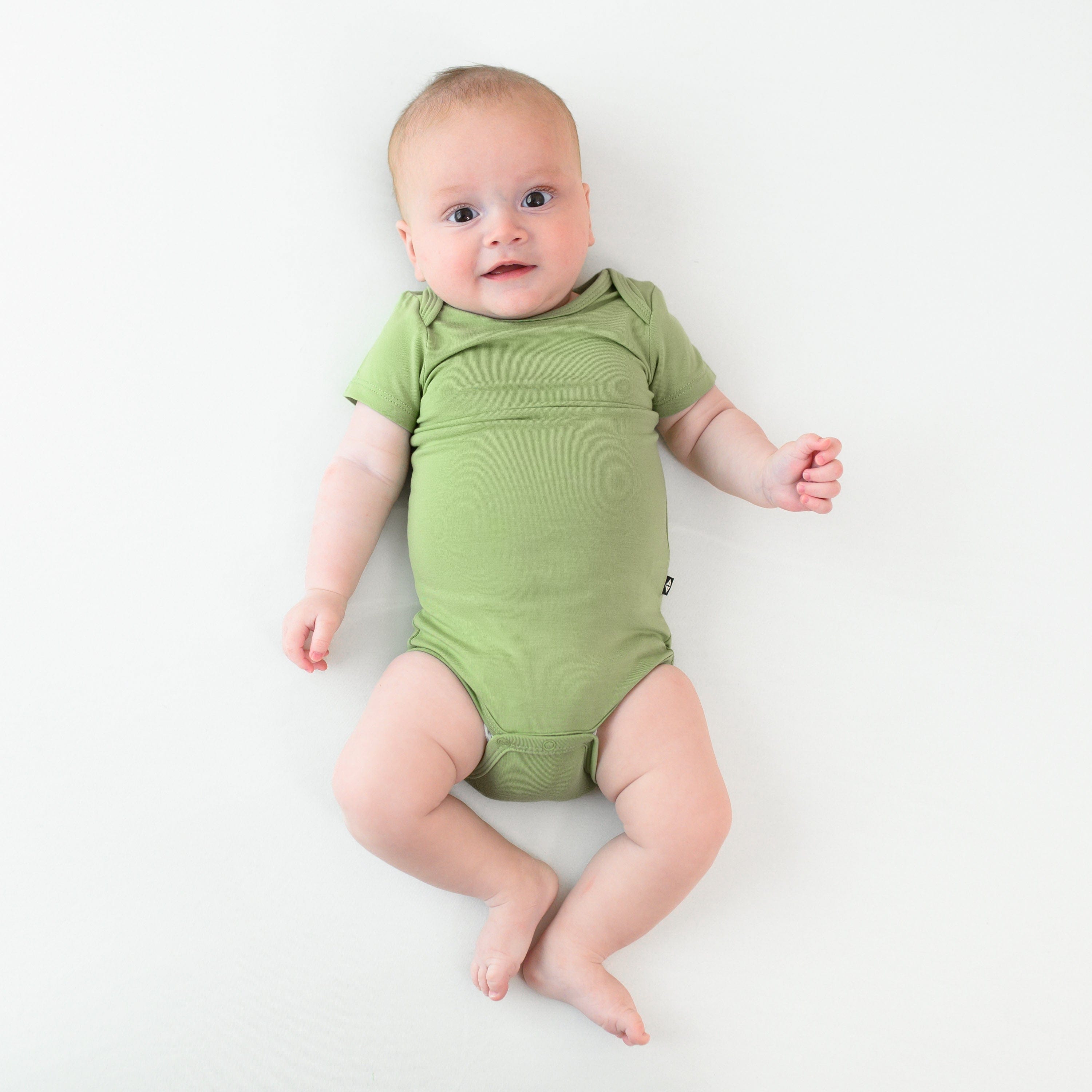 baby wearing kyte baby short sleeve bodysuit in honu