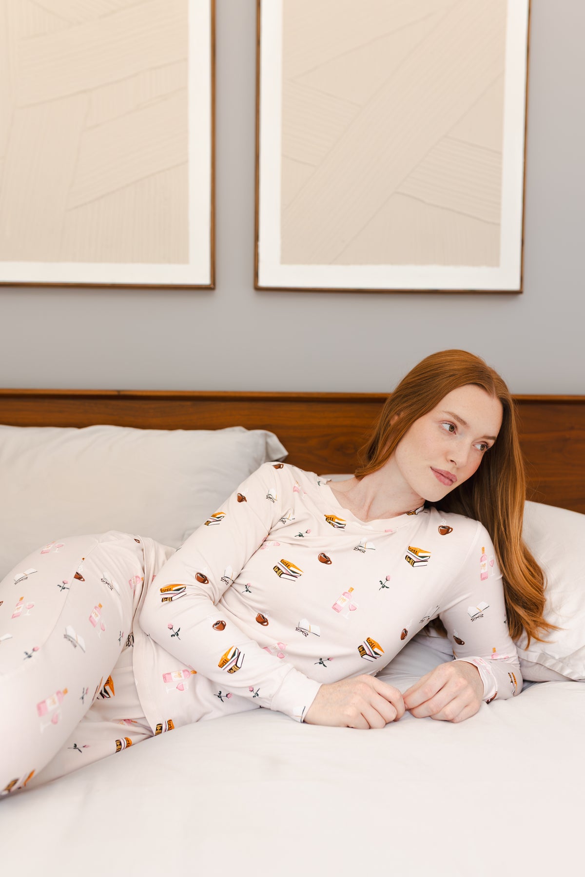 Modal wearing Women's Jogger Pajama Set in Book Club print lying on a bed