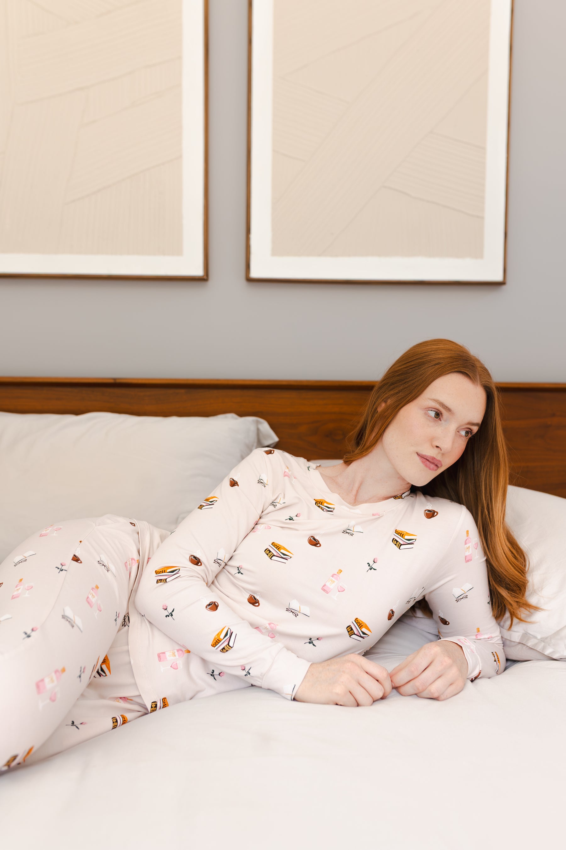 Modal wearing Women's Jogger Pajama Set in Book Club print lying on a bed
