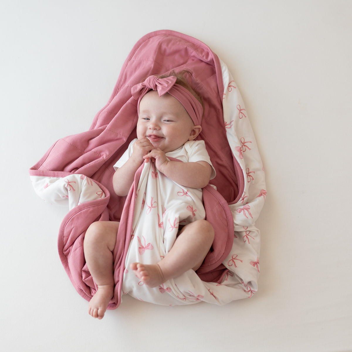 Baby wrapped in Baby Blanket in Bow 1.0 TOG
