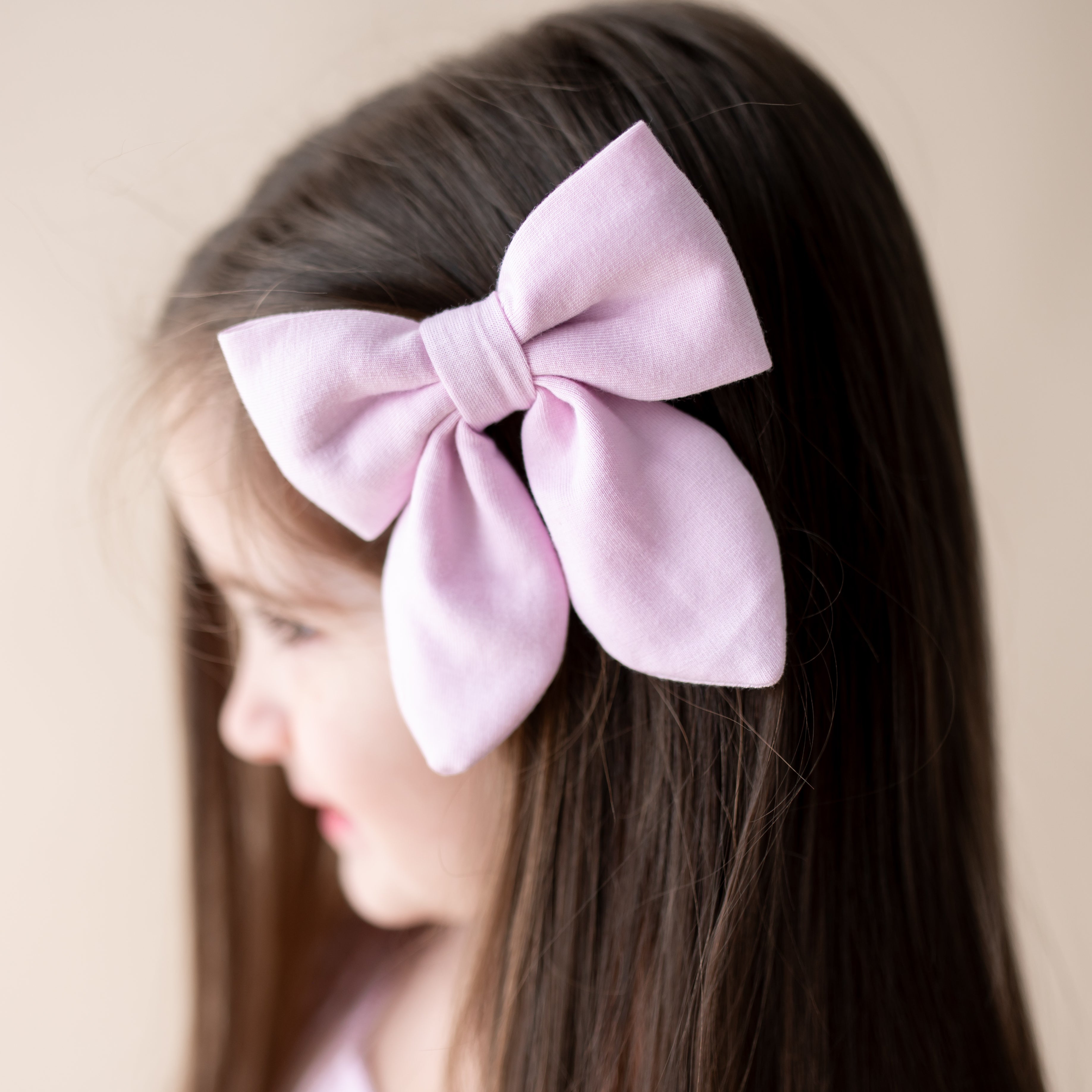 Medium Alligator Clip Bow in Thistle clipped in young girls hair