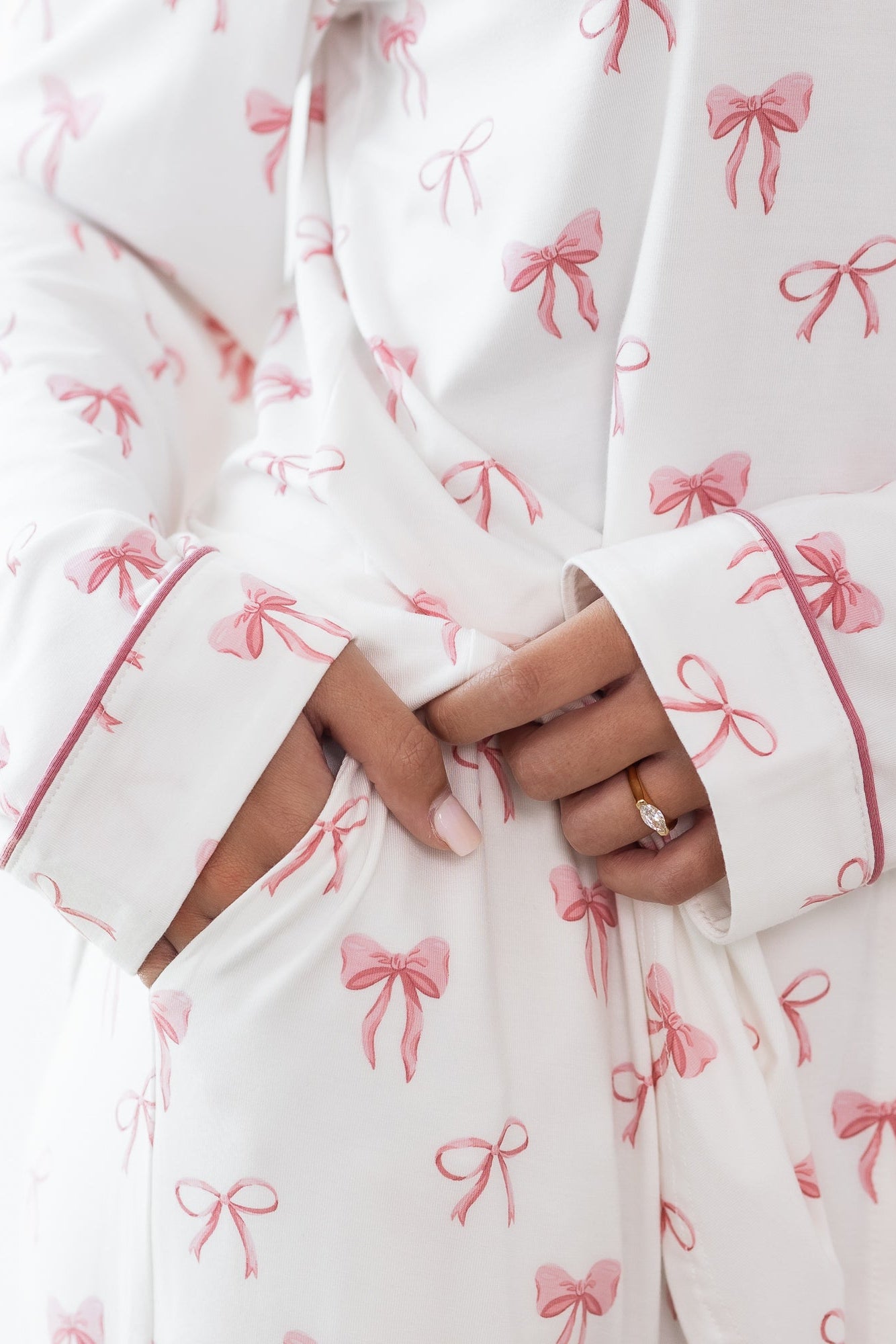 Close up of the pocket detail in the pants of the Long-Sleeved Women's Pajama Set in Bow with the Apple Blossom trim on the sleeve visible