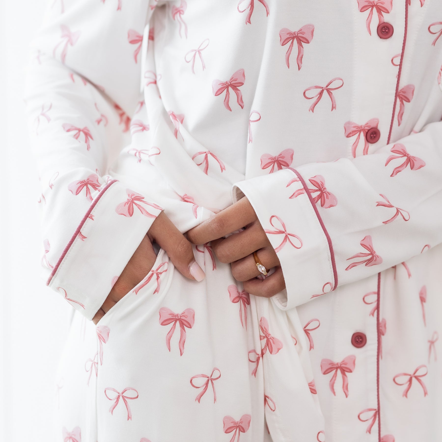 Close up of the pocket detail in the pants of the Long-Sleeved Women's Pajama Set in Bow with the Apple Blossom trim on the sleeve visible