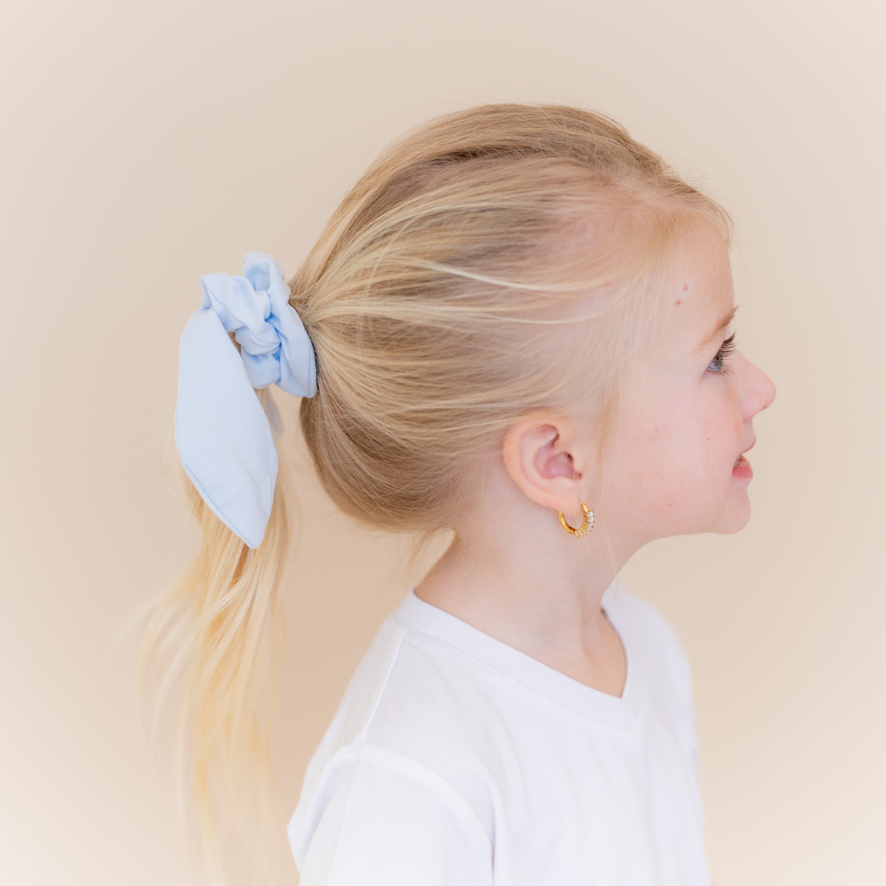 Scrunchie in Breeze shown in a young girls ponytail