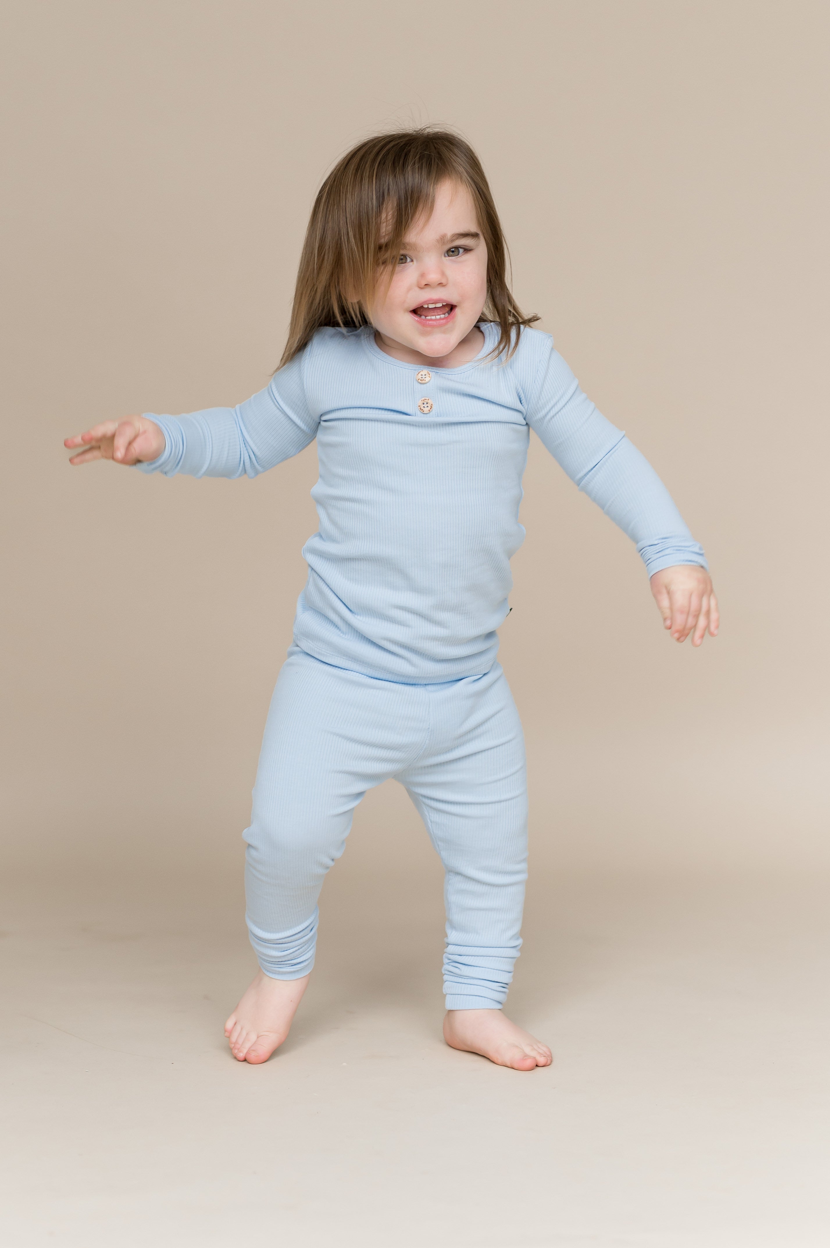 Young child walking wearing the Ribbed Henley Set in Breeze