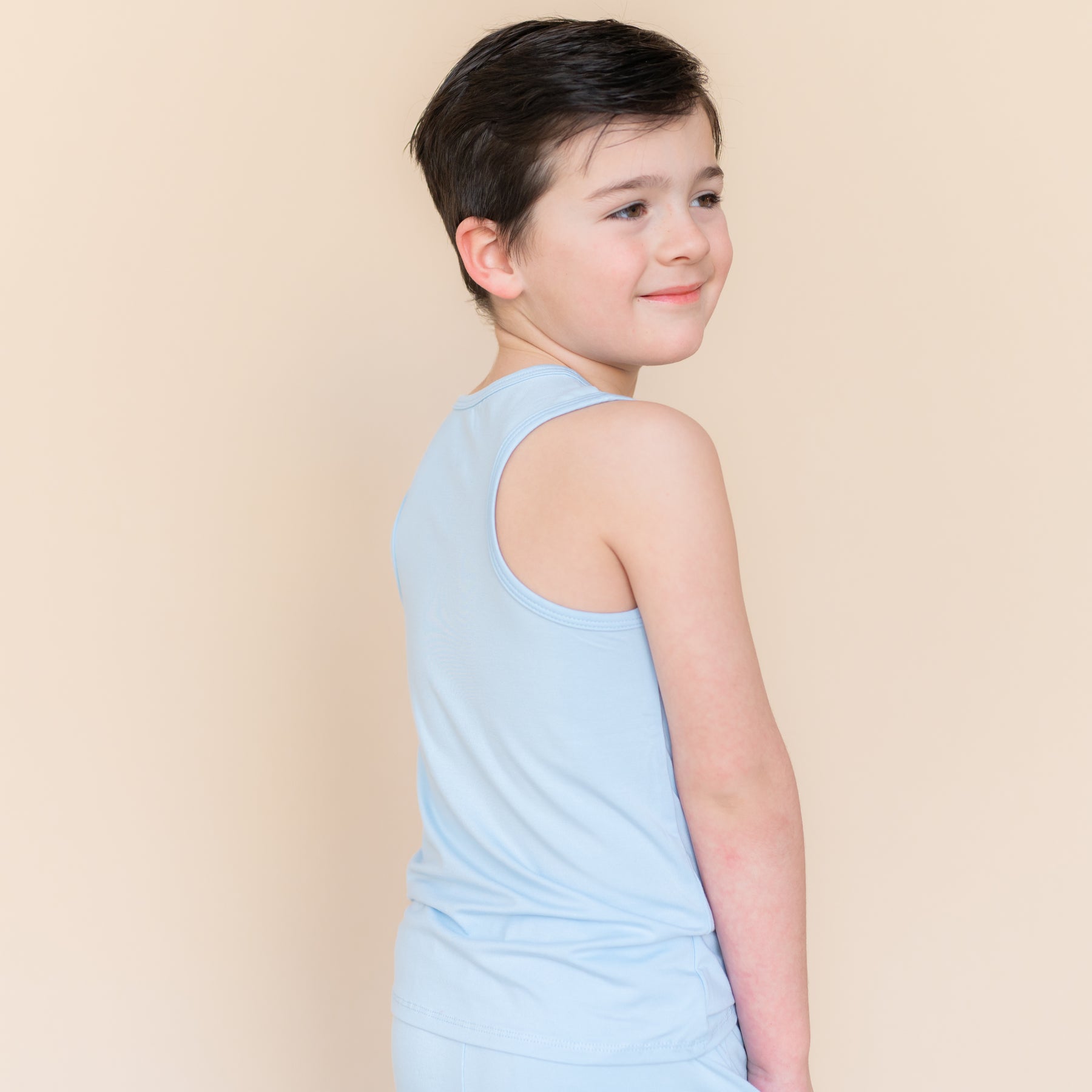 The back of the Toddler Tank Top in Breeze on a model showing the racerback