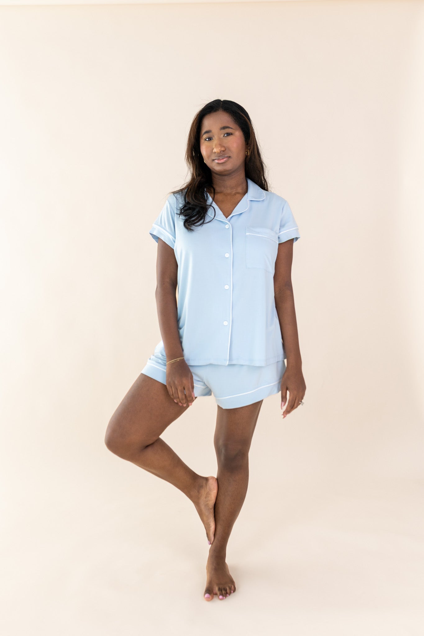 Female posing wearing the Women's Short Sleeve Pajama Set in Breeze in front of a light neutral background