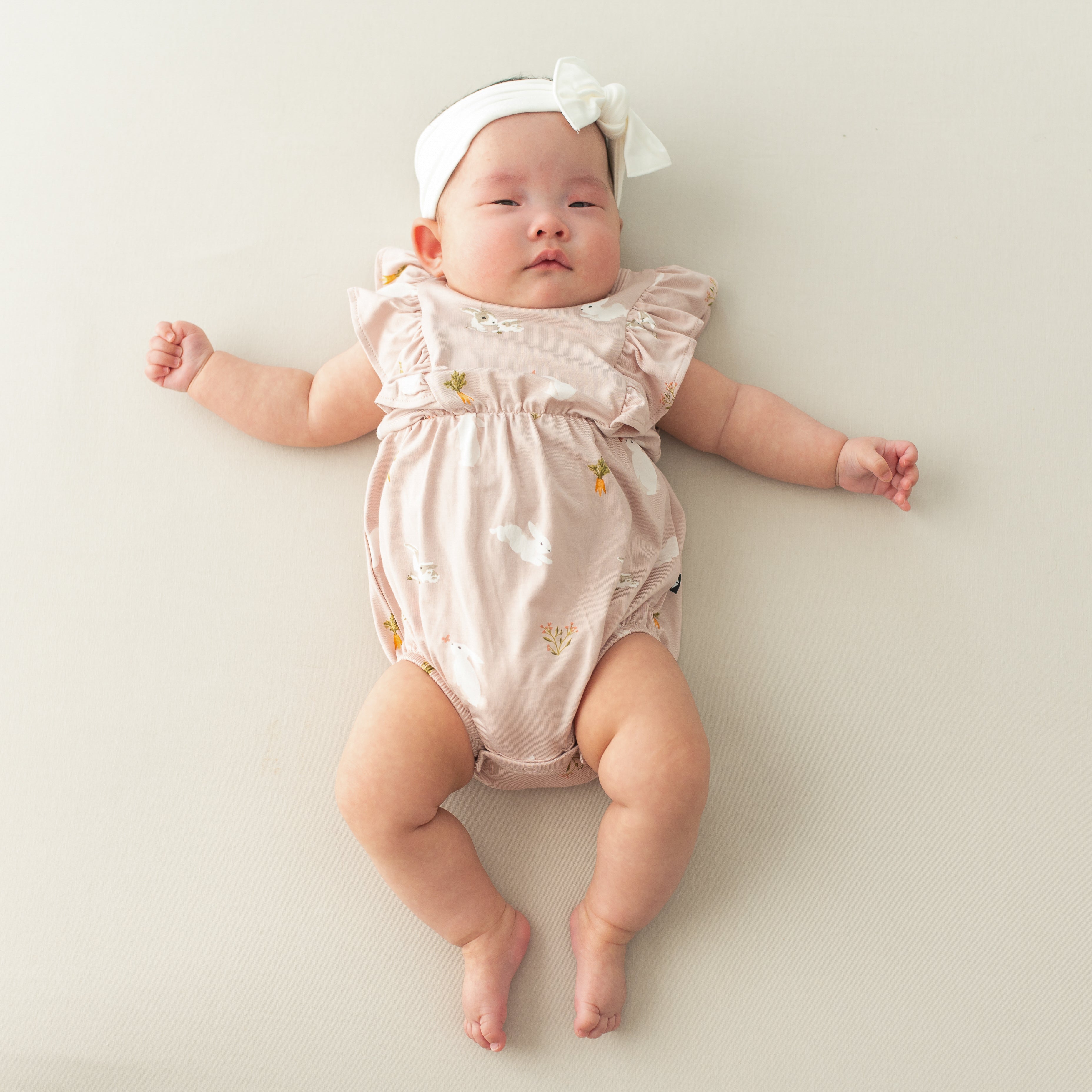 Baby in Bubble Romper in Blush Rabbit and cloud bow