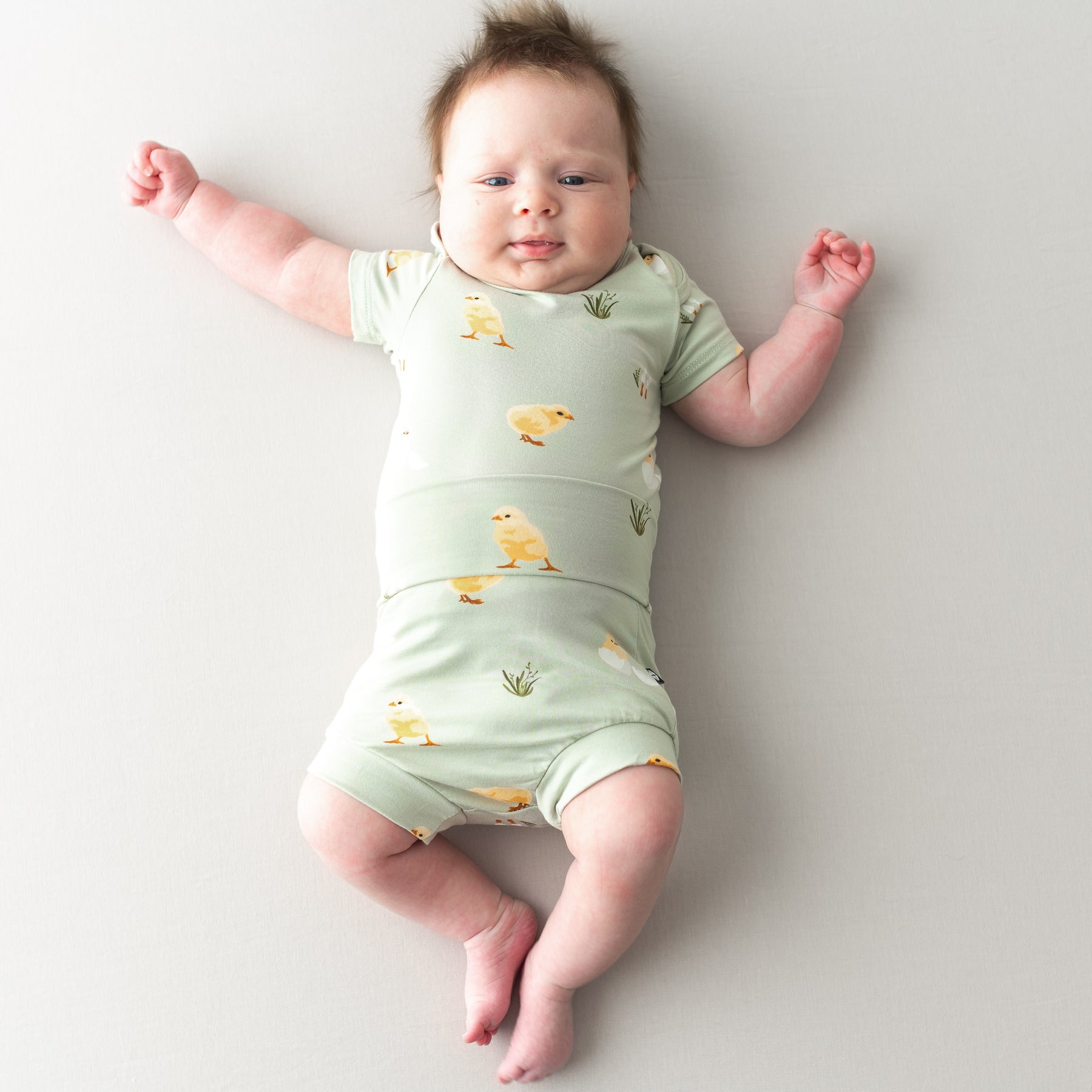 Baby in Bummies in Aloe Chick and short sleeve bodysuit