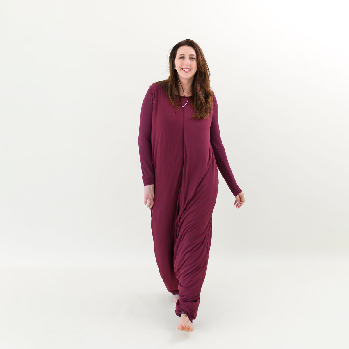 Smiling female walking in the Adult Sleep Bag Walker in Burgundy