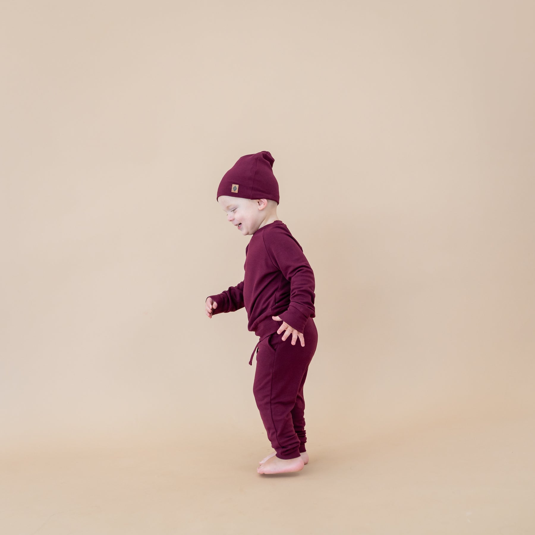 Toddler wearing Bamboo Jersey Beanie in Burgundy and matching jogger set