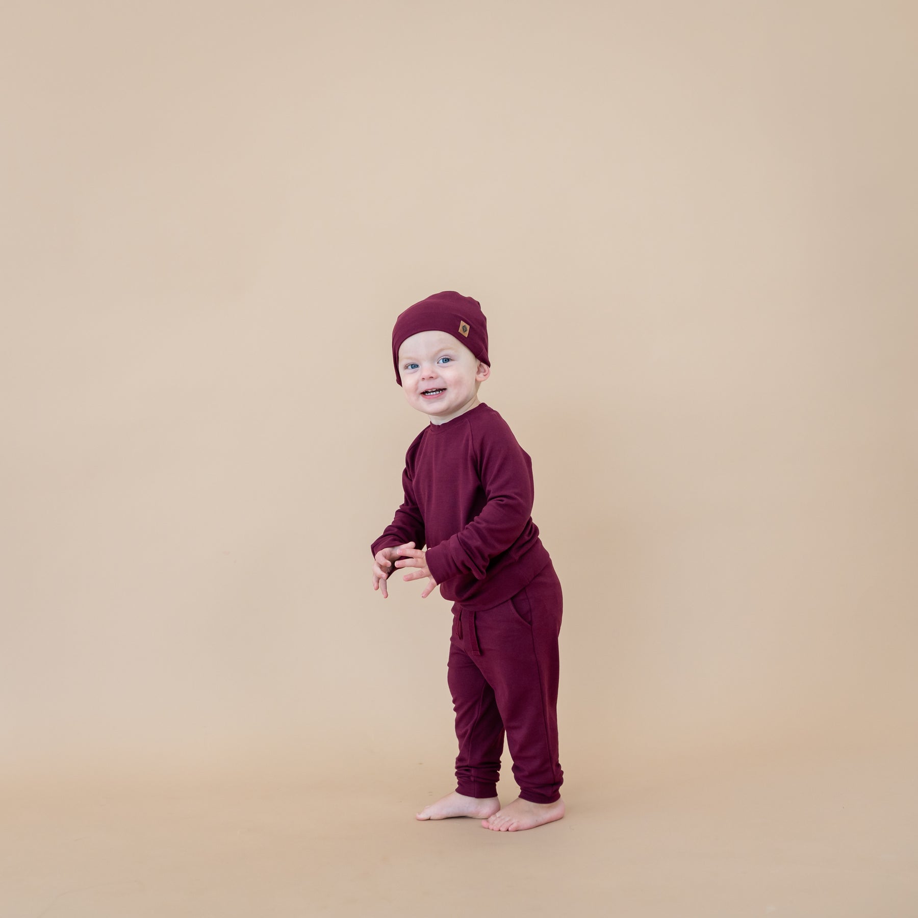 Toddler wearing Bamboo Jersey Jogger Set in Burgundy with matching beanie