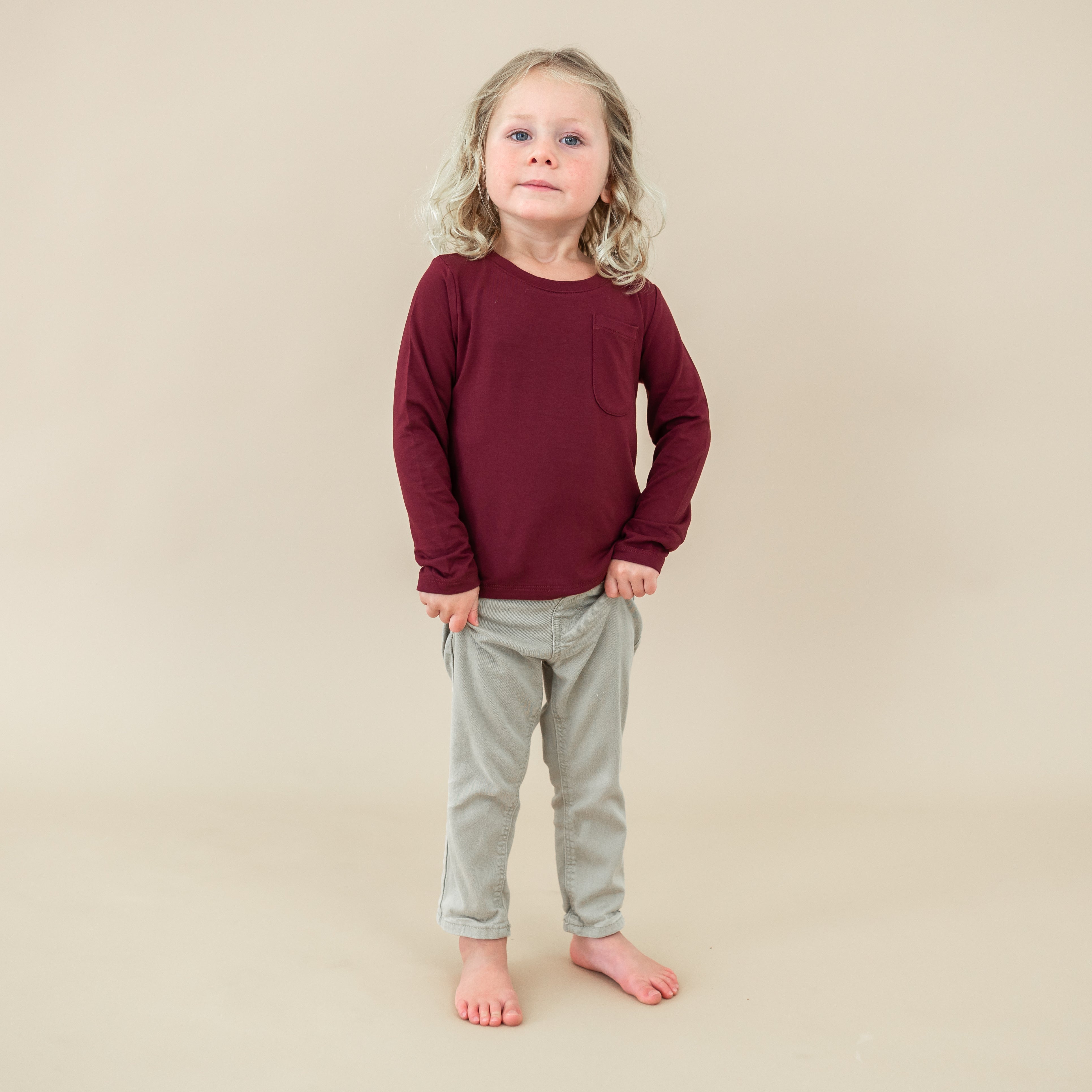 Toddler wearing the Long Sleeve Toddler Crew Neck Tee in Burgundy with light wash jeans