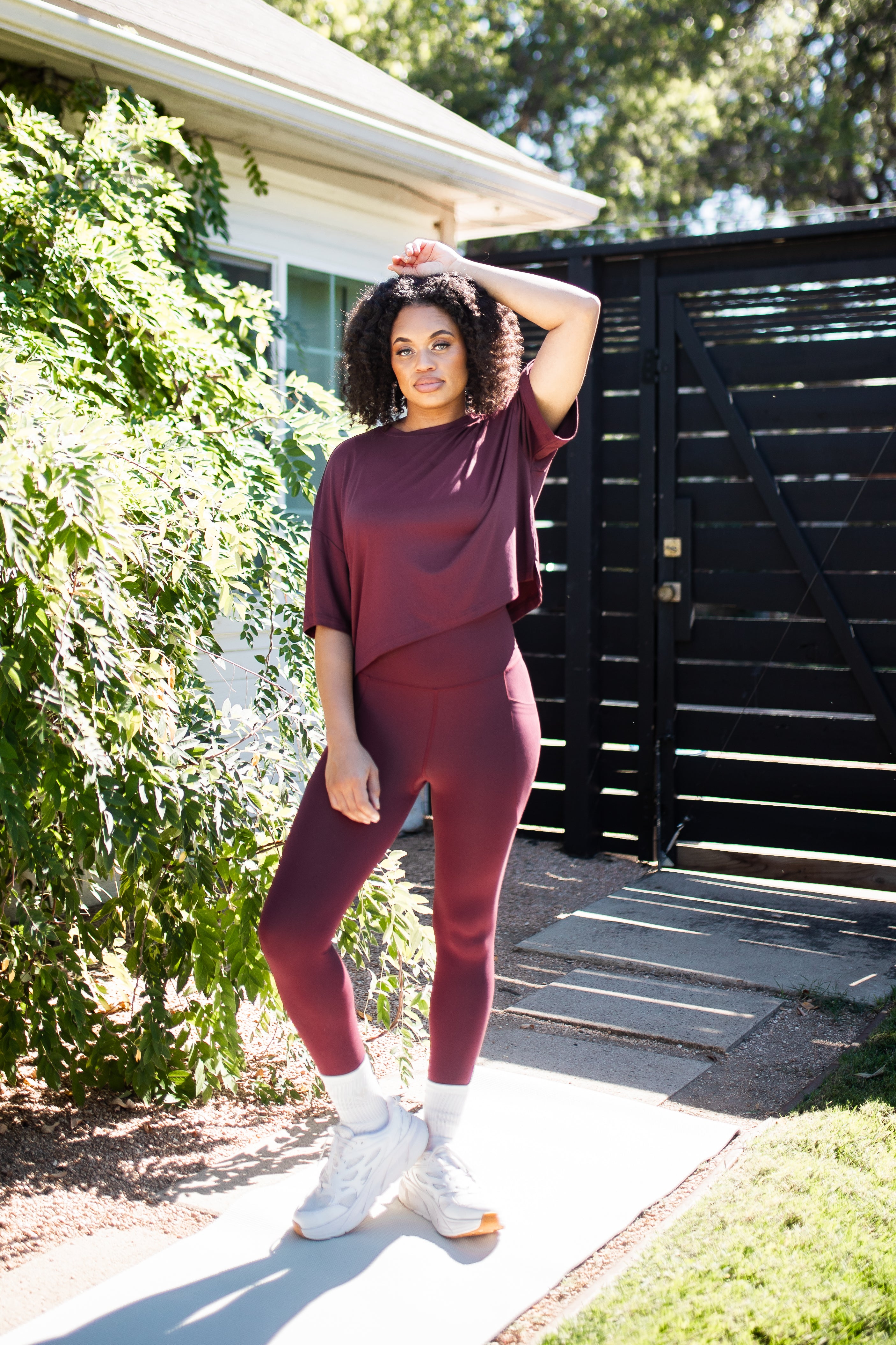 Female standing outside wearing the Bamboo Flex Women’s Leggings in Burgundy with matching short sleeve tee