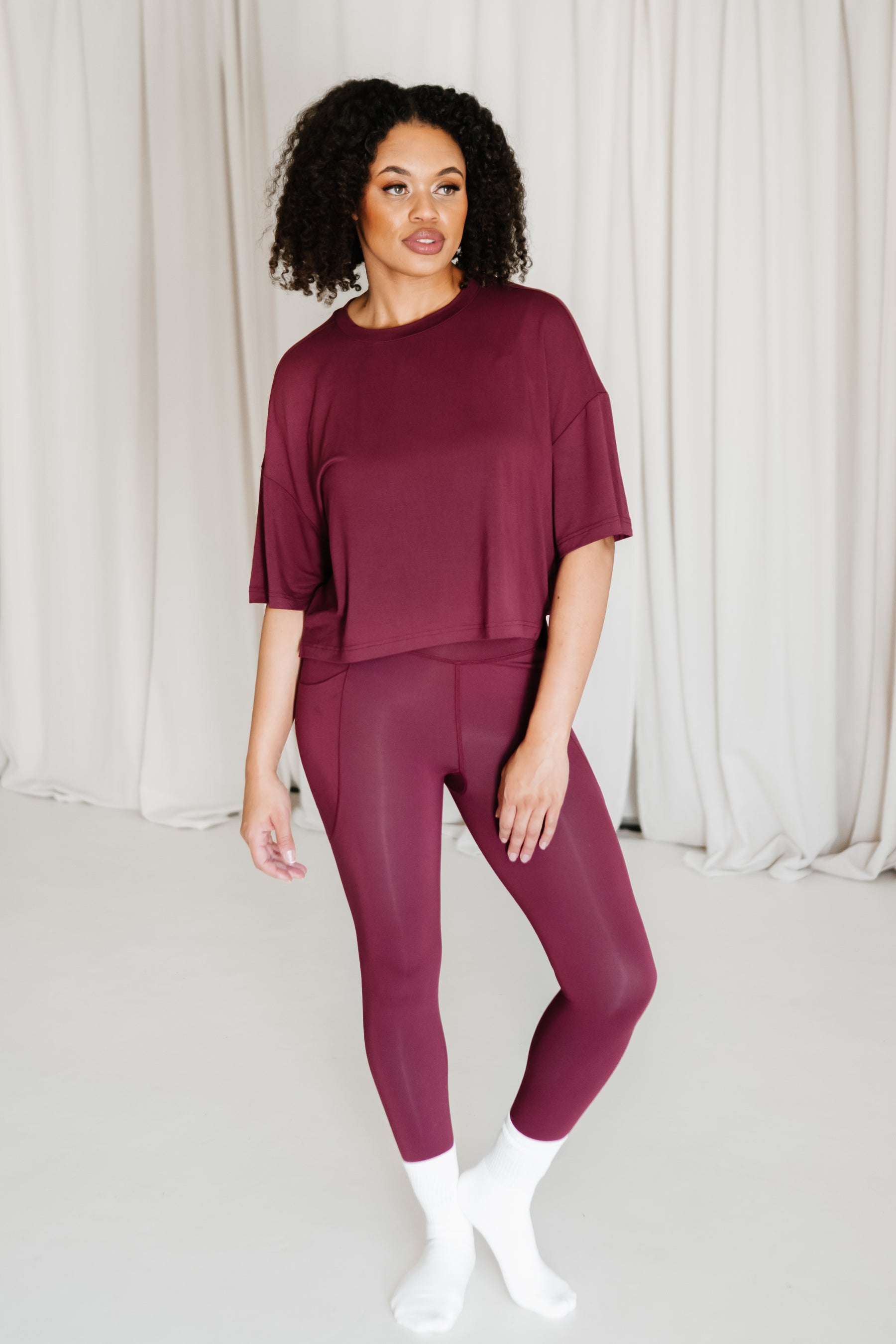Female wearing the Bamboo Flex Women’s Leggings in Burgundy with matching short sleeve tee