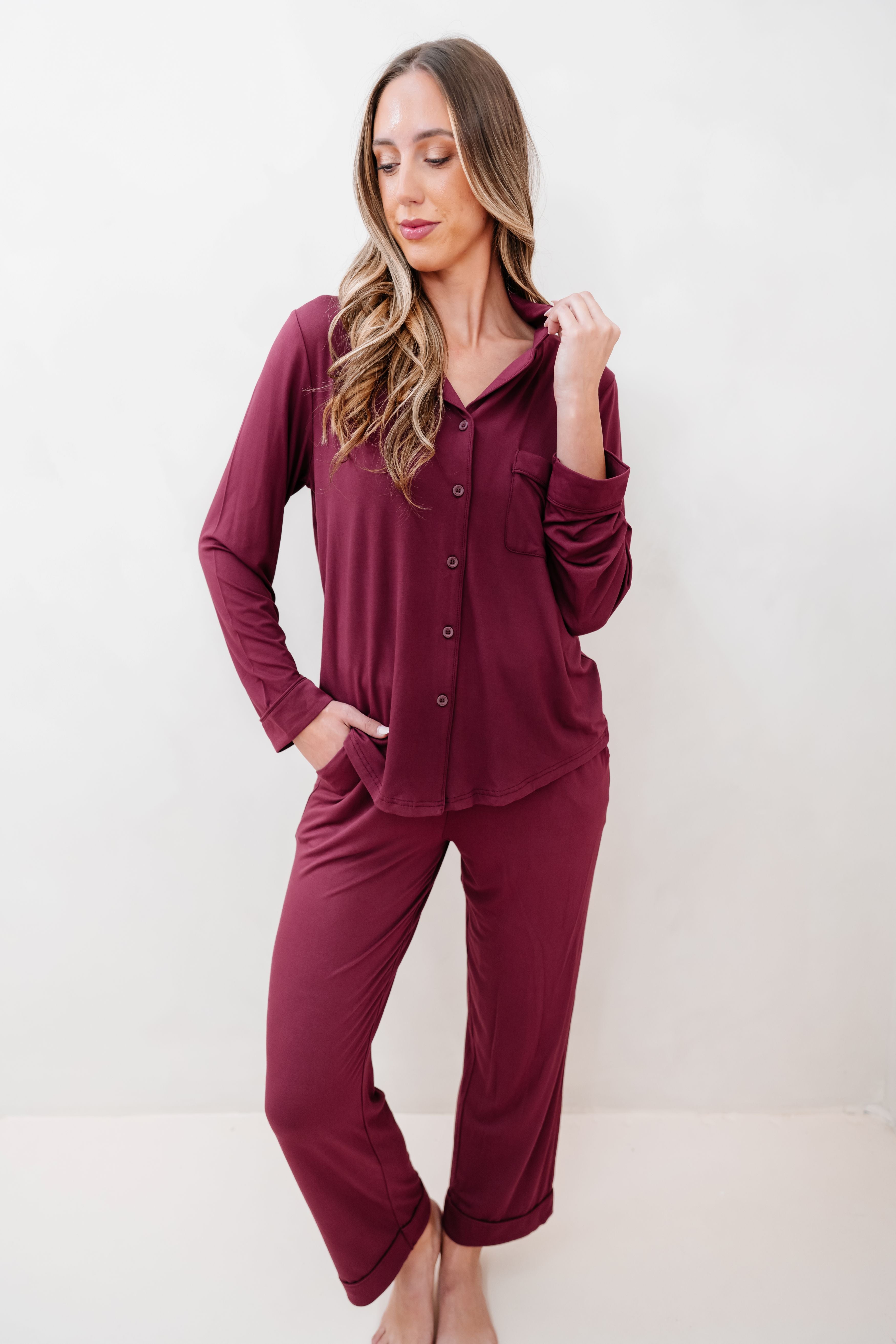 Female modeling the Long-Sleeved Women's Pajama Set in Burgundy with Burgundy Trim in front of a light backdrop