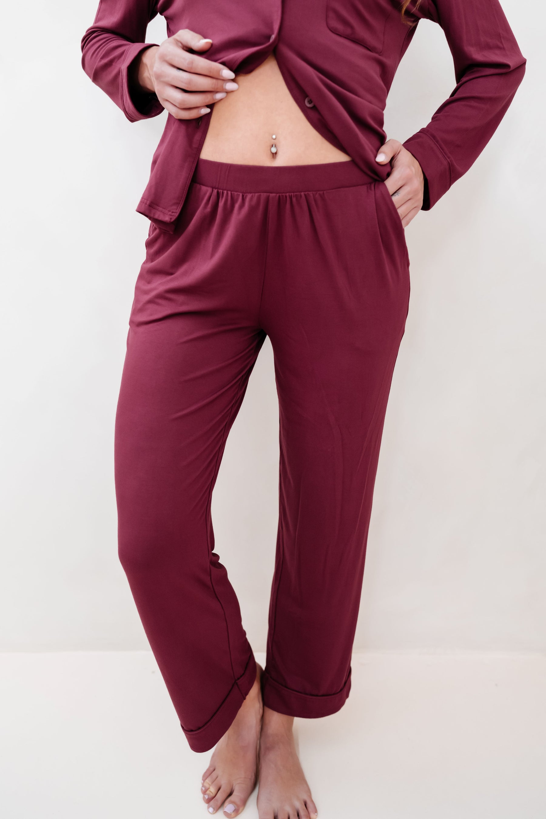 The flat waistband of the pants of the Long-Sleeved Women's Pajama Set in Burgundy with Burgundy Trim shown on a model