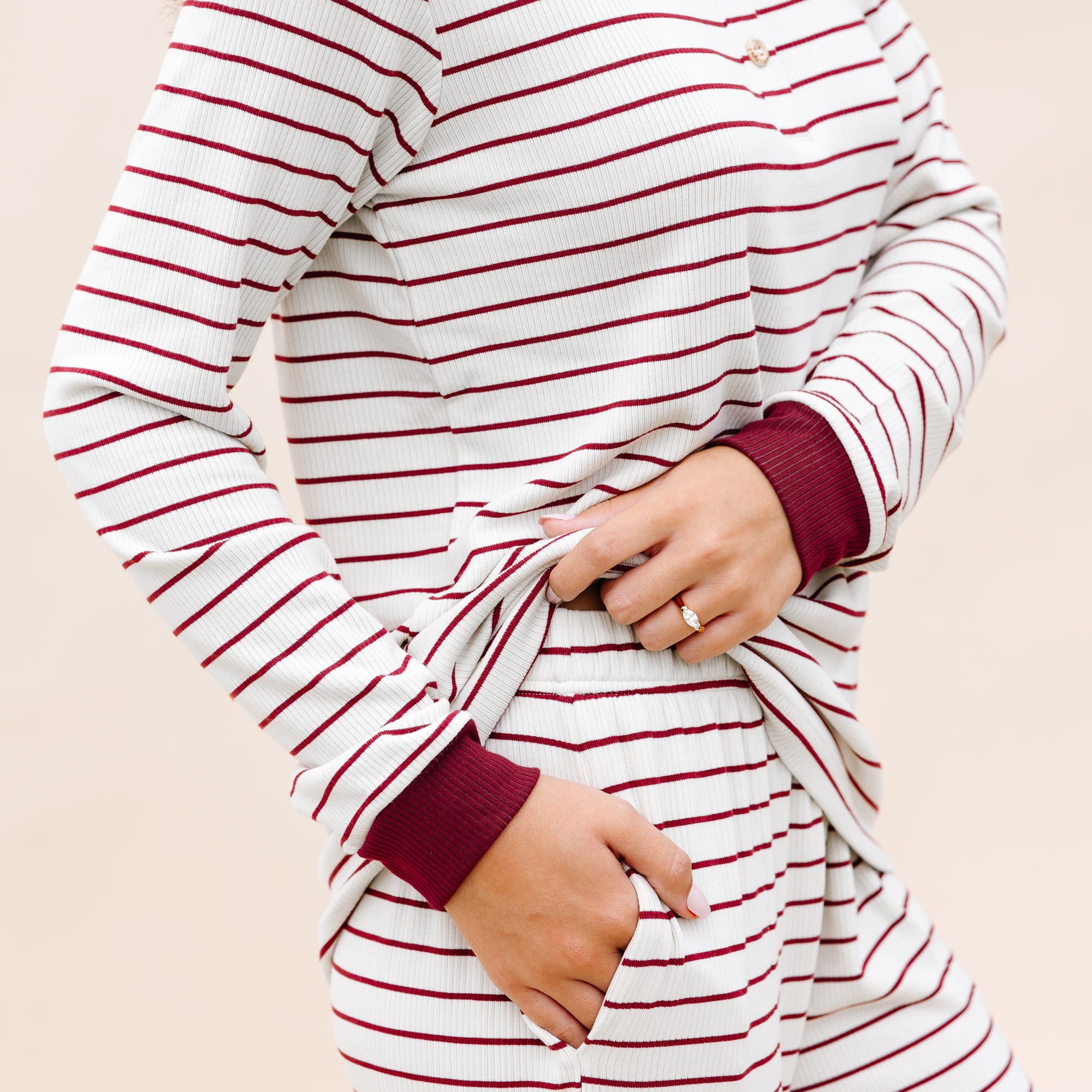 Close up of the elastic waist band and side pockets of the Women’s Ribbed Henley Set in Burgundy Stripe shown on a model