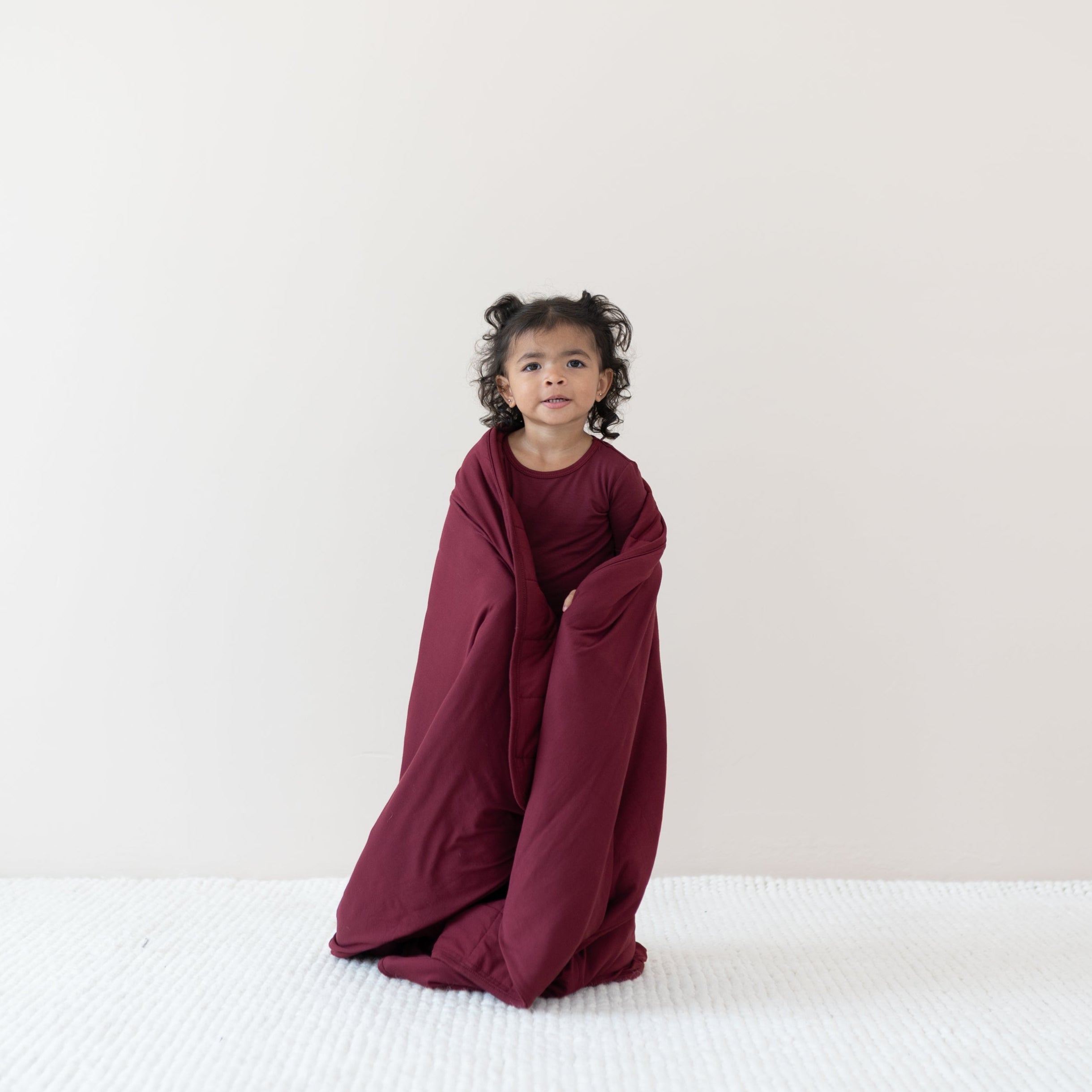 Toddler standing wrapped in the Toddler Blanket in Burgundy 2.5