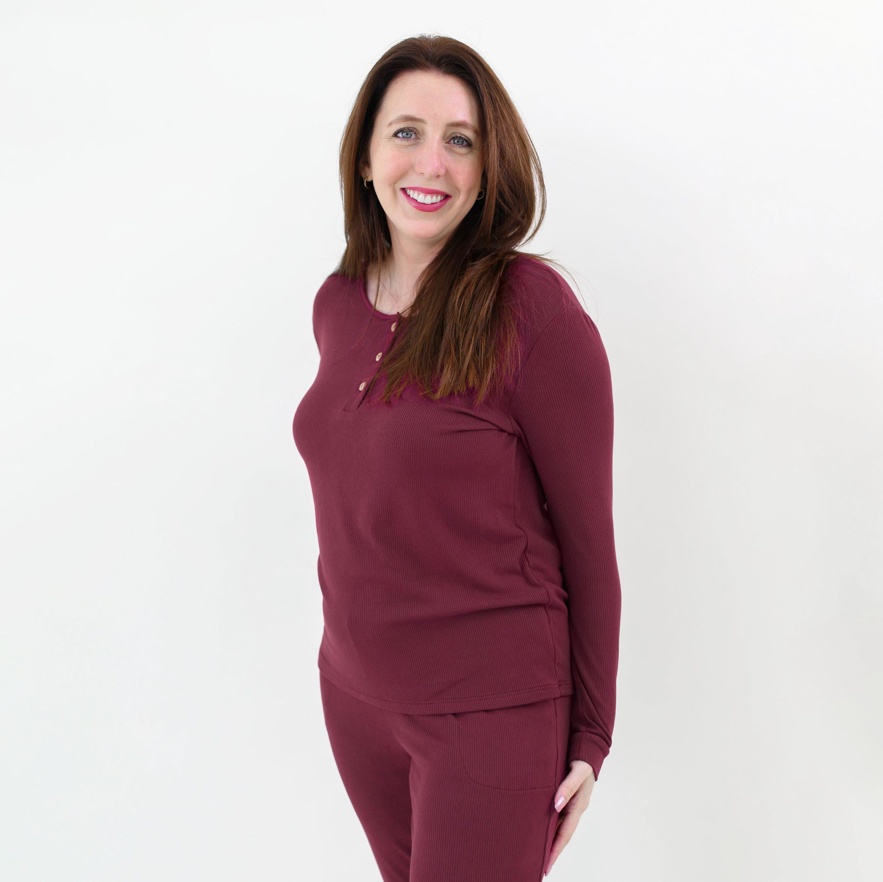 Close up on the top of the Women’s Ribbed Henley Set in Burgundy shown on a smiling female model