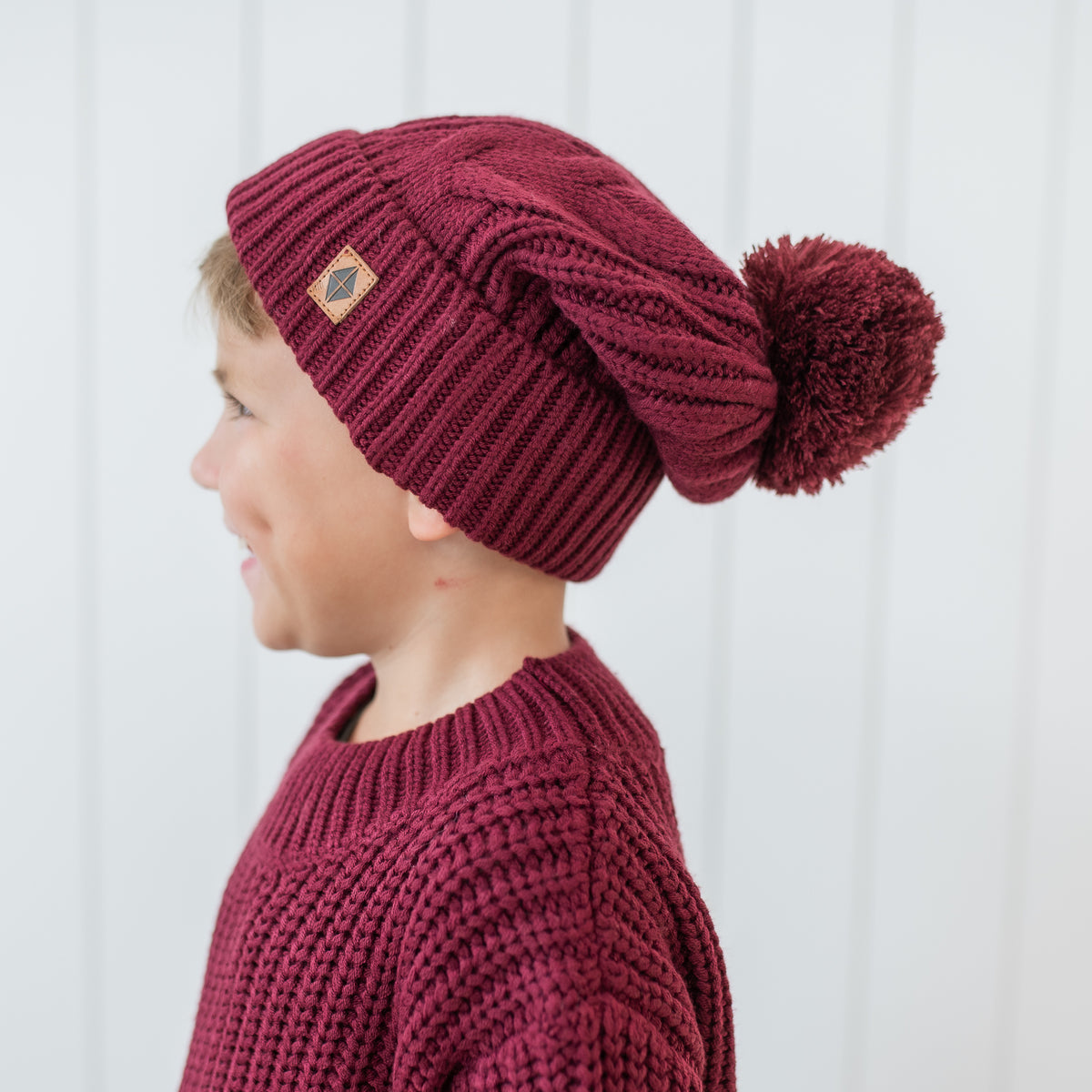 Chunky Cable Knit Beanie in Burgundy shown on a young boy