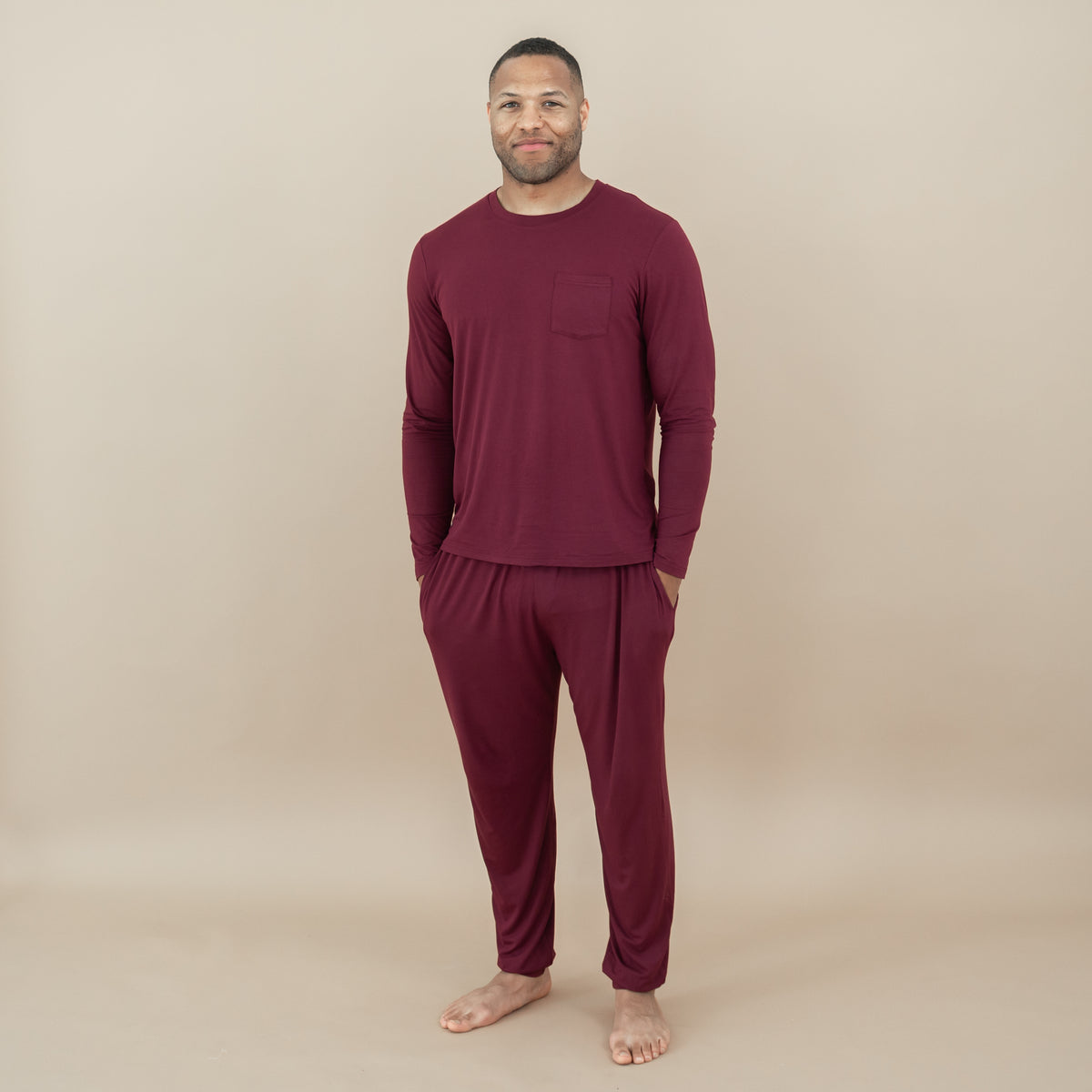 Male model standing with hands the pockets of the Men's Jogger Set in Burgundy