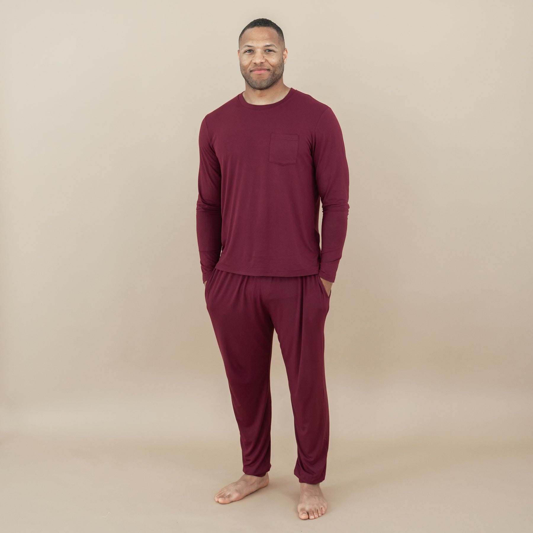Male model standing with hands the pockets of the Men's Jogger Set in Burgundy