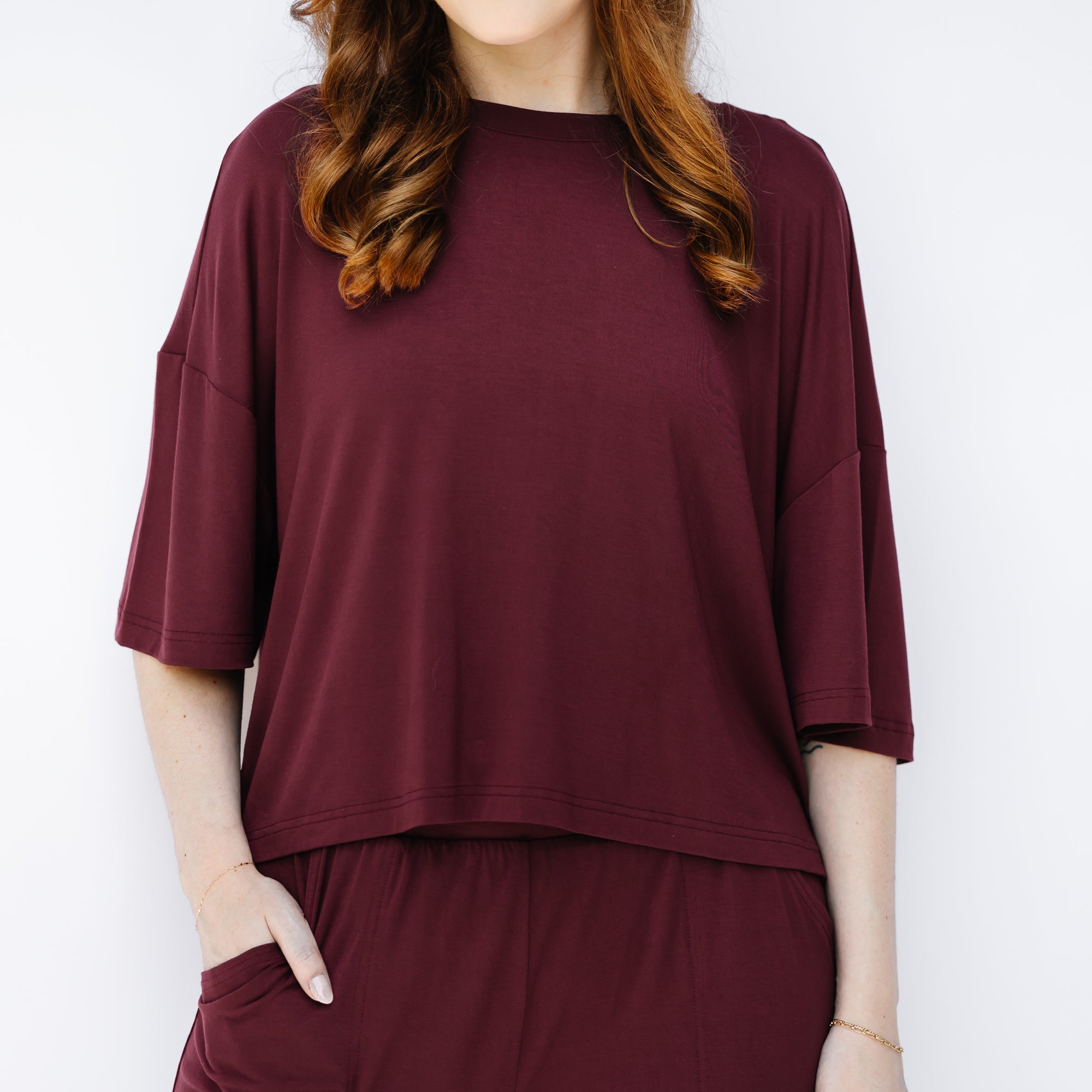 Women's Short Sleeve Tee in Burgundy shown on a female model wearing the matching wide leg pant