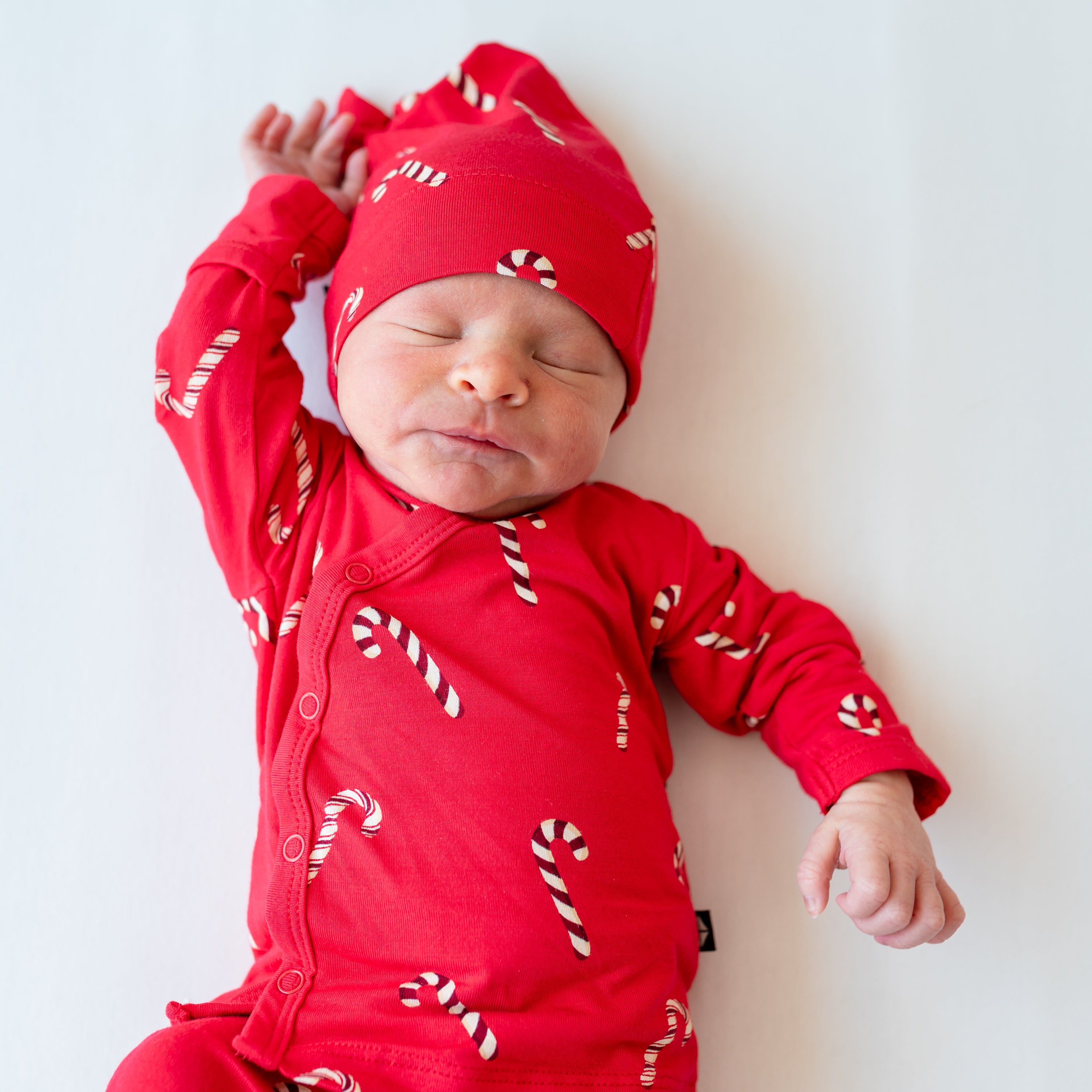 Close up of newborn wearing the Take Me Home Set with Cap in Candy Cane
