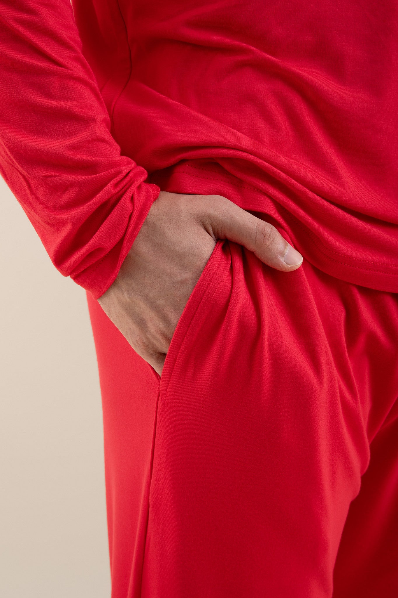 The pocket of the pants shown of the Men's Jogger Set in Cardinal on a male model