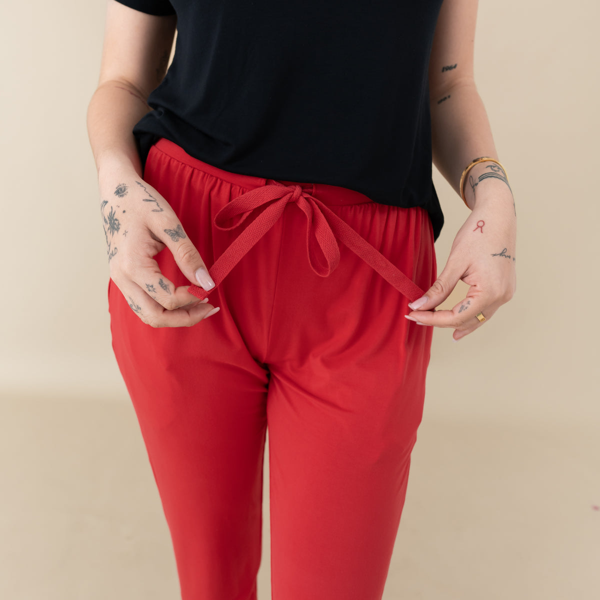 Woman modeling Women's Jogger Pants in Cardinal close up on waist tie
