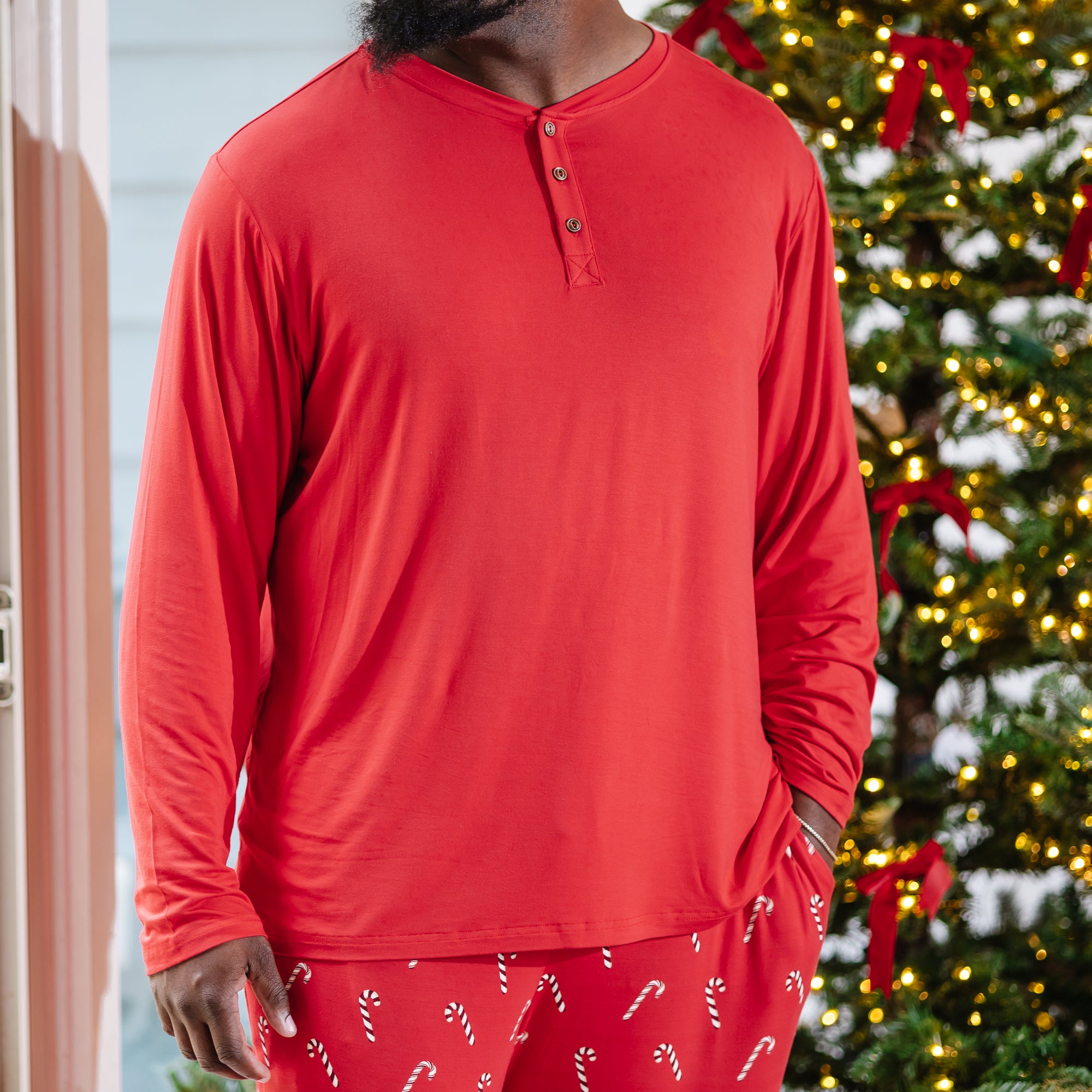 Close up of the Men's Long Sleeve Henley Top in Cardinal shown on a model