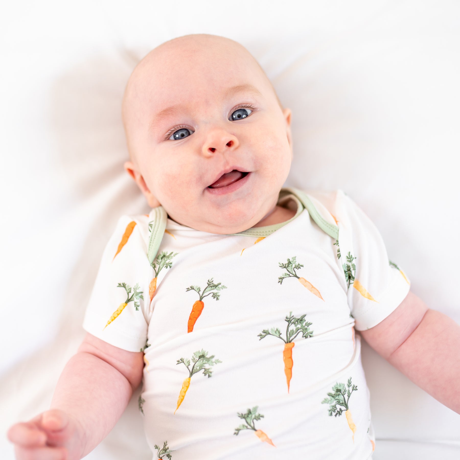 Close up of infant wearing the Bodysuit in Carrot