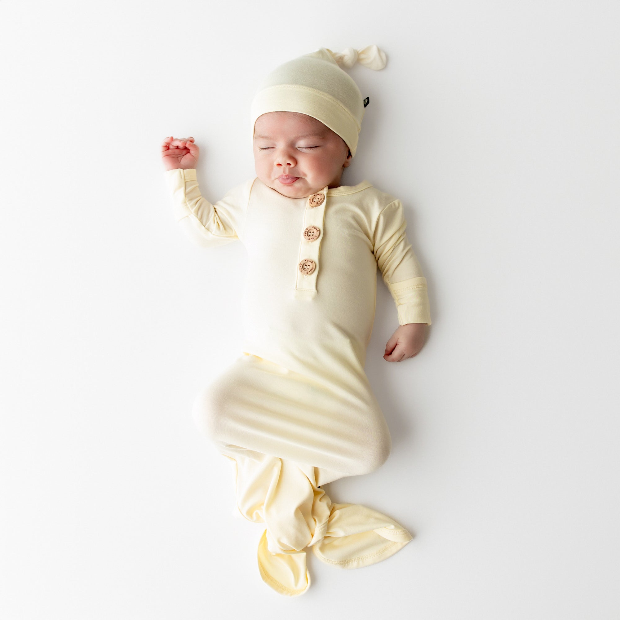 Baby sleeping in Knotted Gown with Hat Set in Chamomile