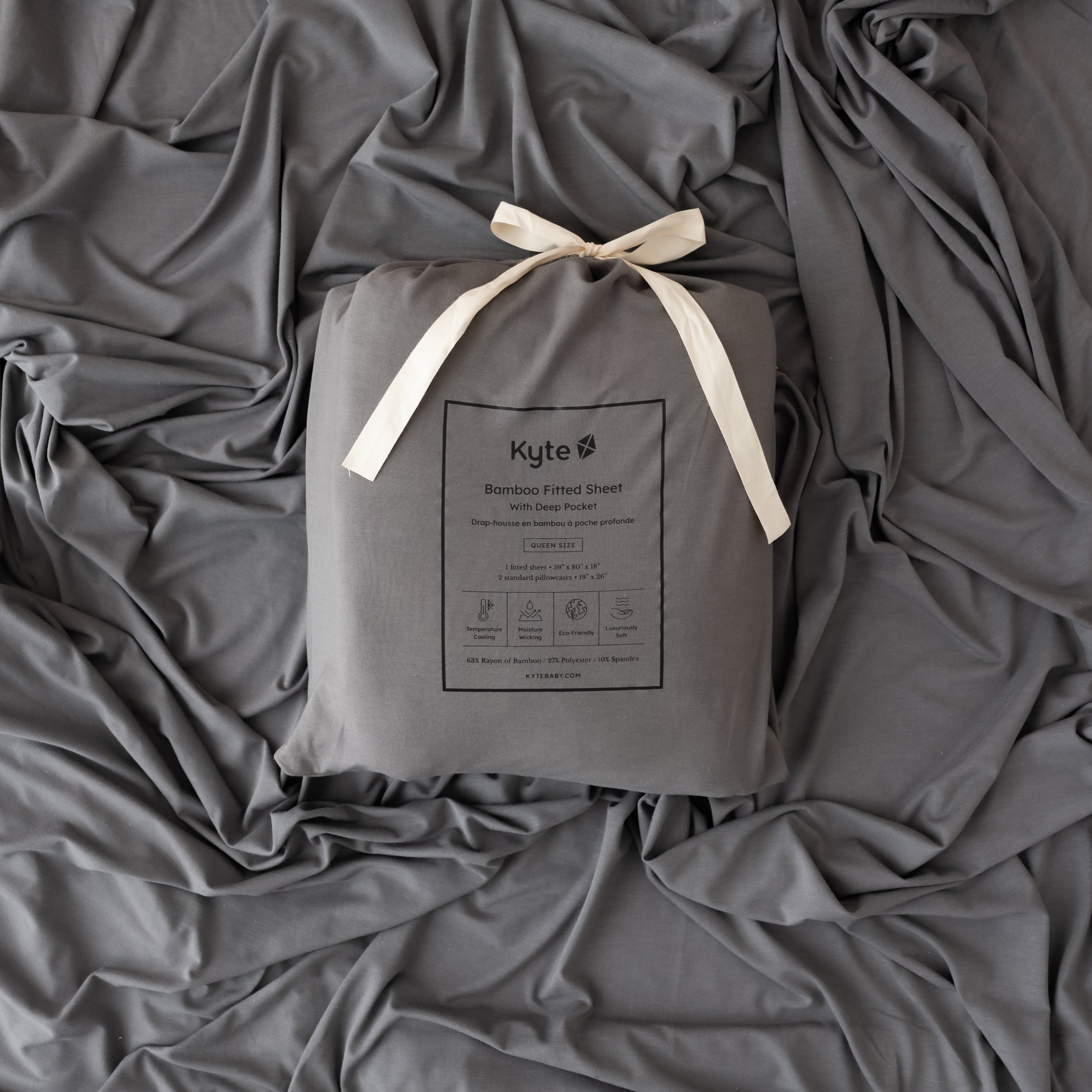 charcoal sheet packaging laying on top of a charcoal fitted sheet