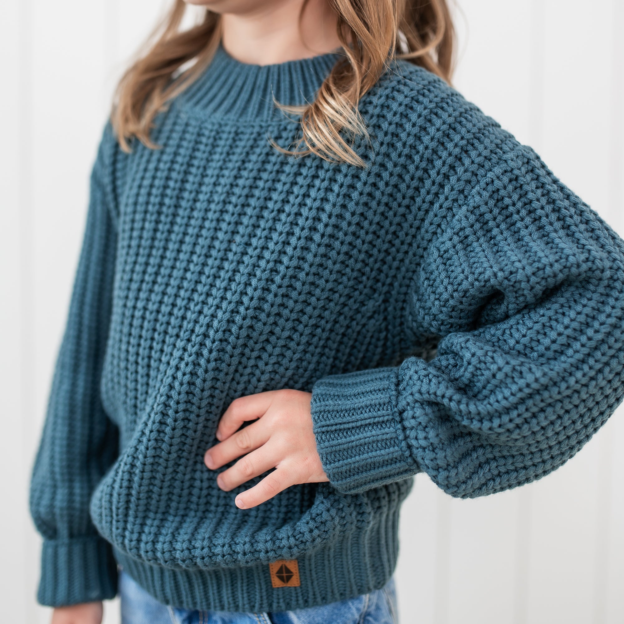 Close up of the knit fabric on the Chunky Knit Sweater in Atlantic show on a model