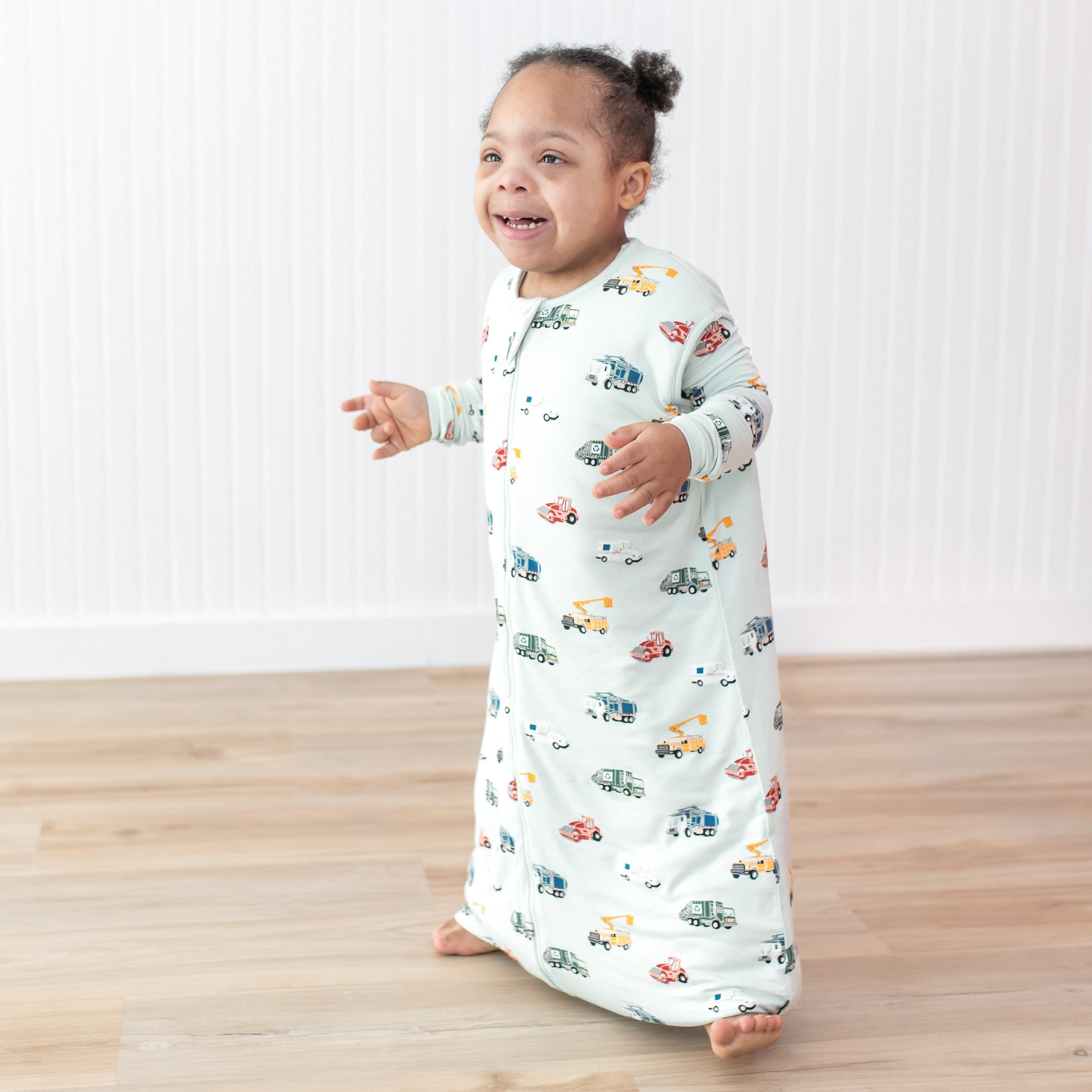 Young smiling child walking wearing the moisture wicking Sleep Bag Walker in City Vehicles 1.0