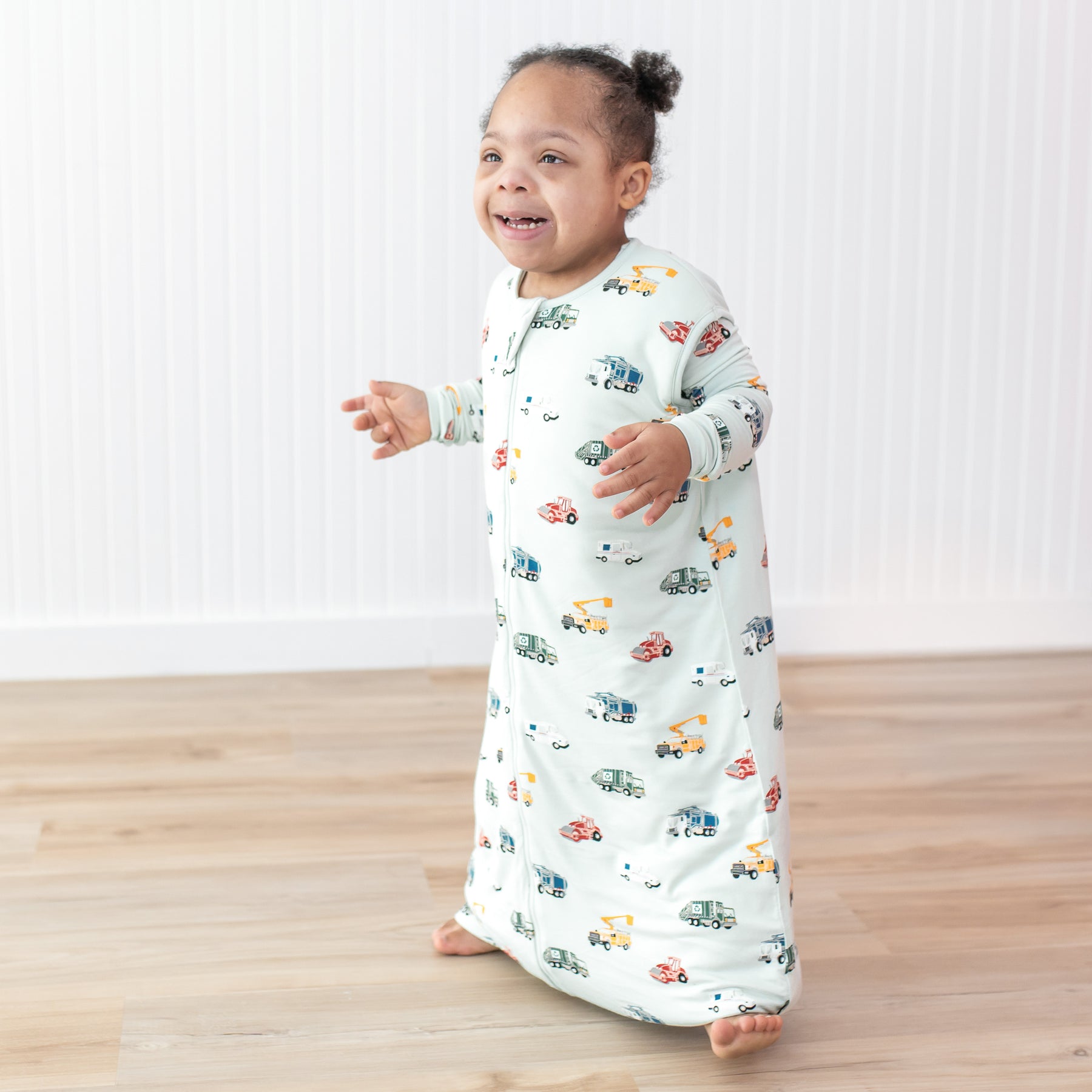 Young smiling child walking wearing the moisture wicking Sleep Bag Walker in City Vehicles 1.0