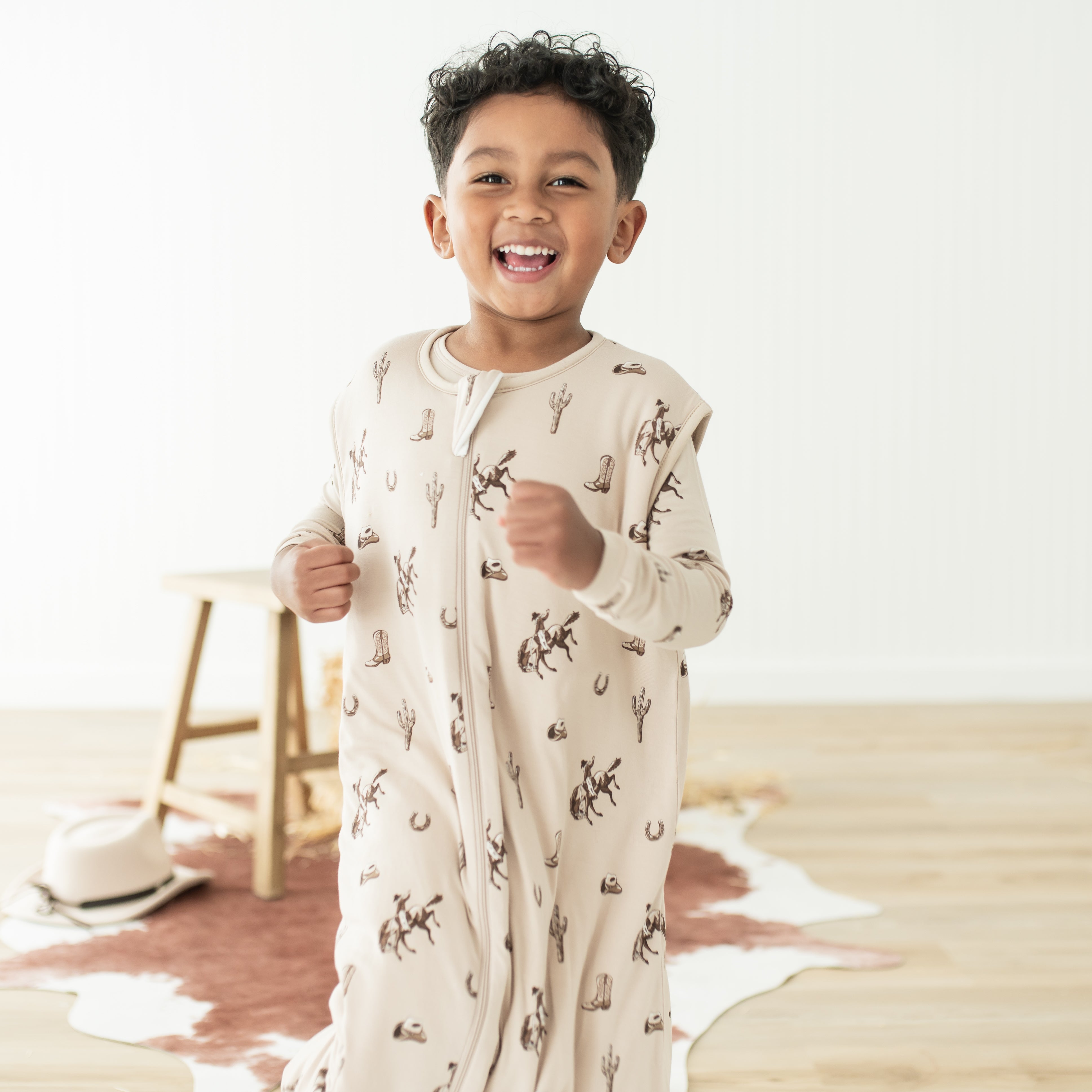 Close up of smiling boy wearing the Sleep Bag Walker in Classic Cowboy 1.0