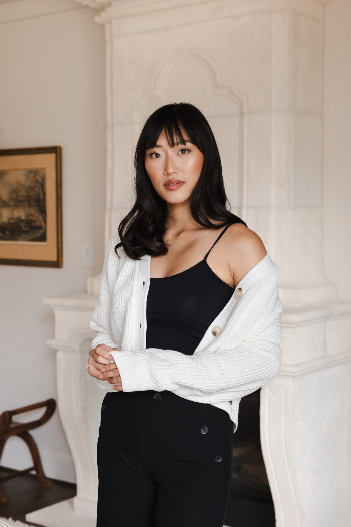 Modal wearing Chunky Knit Women's Cropped Cardigan in Cloud over a black camisole and pants