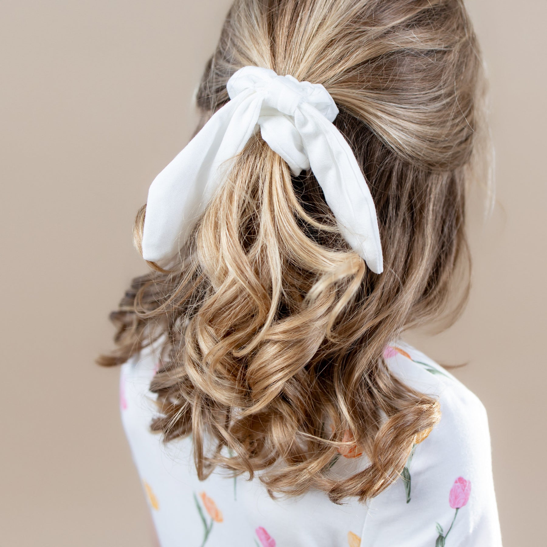 Scrunchie in Cloud shown in a young girls hair